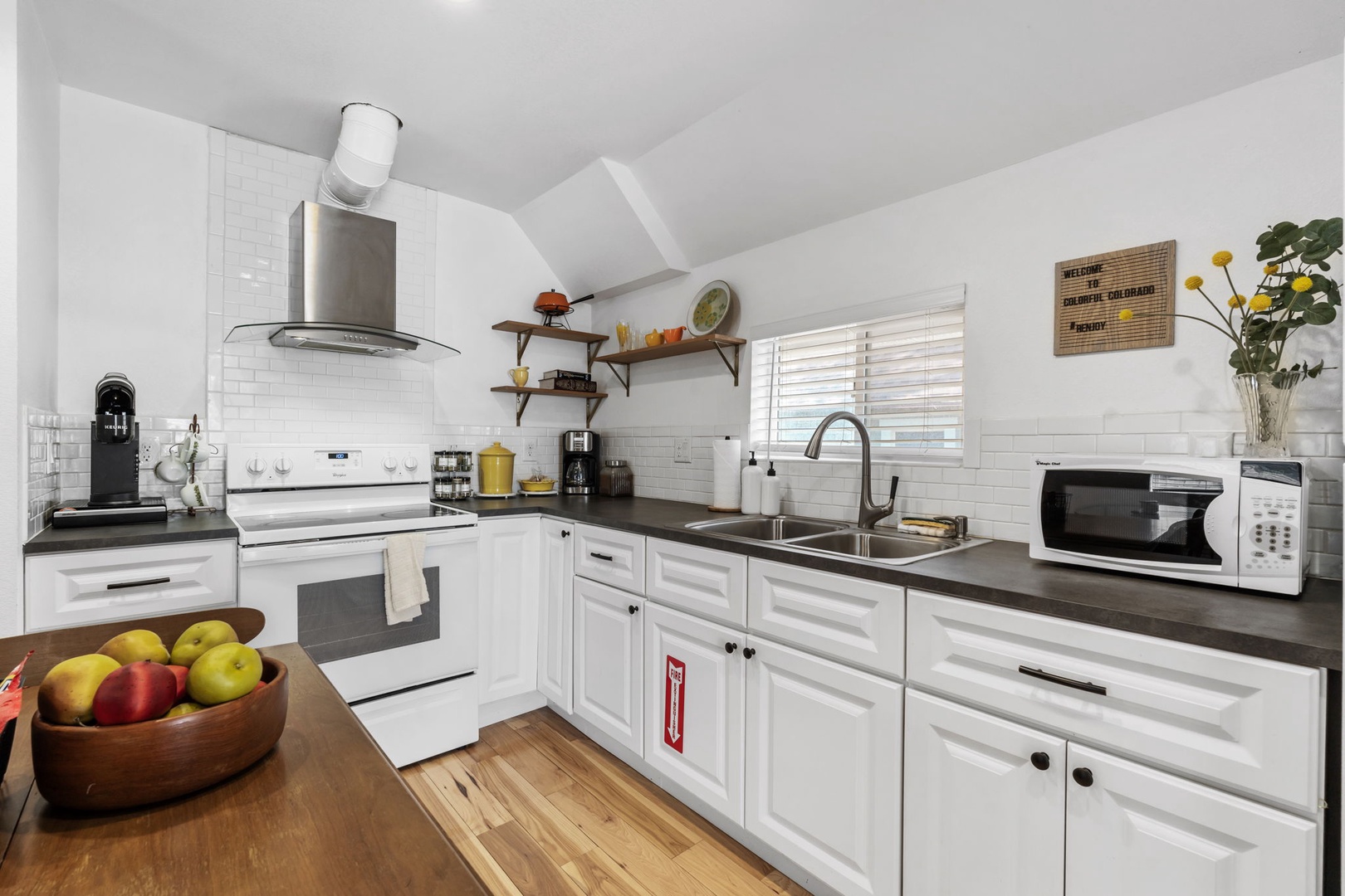 Cook your favorite meals in this bright, fully-equipped kitchen with modern appliances and ample counter space for meal prep.