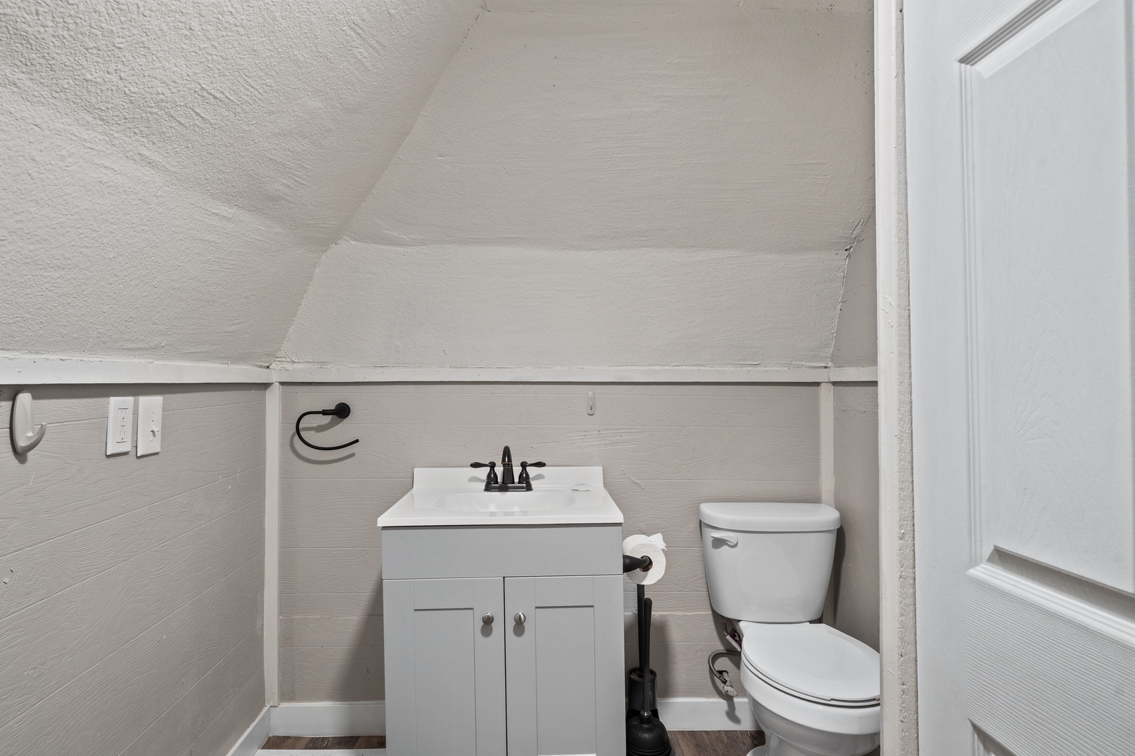 Clean, compact powder room with modern vanity and convenient guest amenities for your comfort.