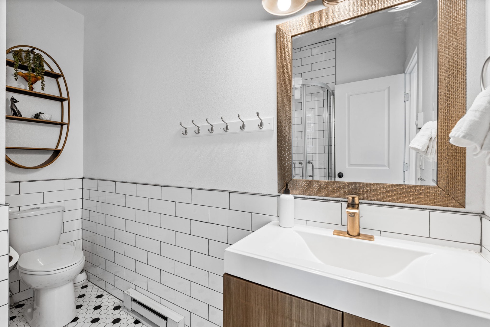 Freshen up in your stylish bathroom featuring subway tiles, warm wood accents, and modern fixtures that create a perfect blend of comfort and elegance.