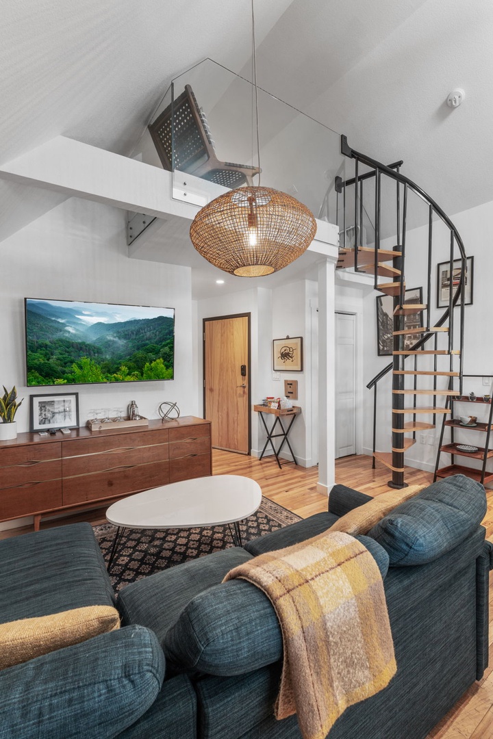 Sink into your plush sofa beneath soaring ceilings, where modern comfort meets artistic design in this stylish multi-level retreat.