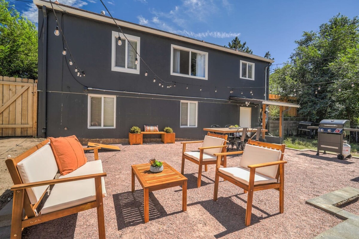 Stylish backyard retreat with modern teak furniture, string lights, and BBQ - your perfect outdoor entertaining space.