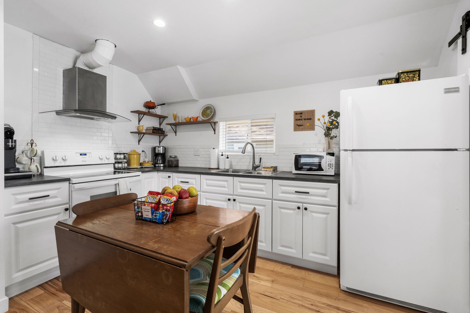 Your fully equipped kitchen awaits with modern appliances, granite counters, and charming subway tile—perfect for preparing meals at home.