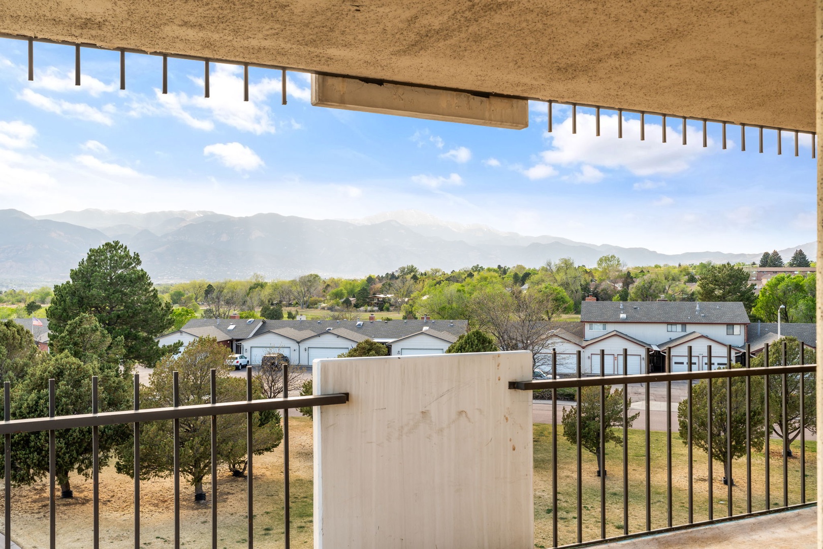 Mountain views frame the neighborhood from this covered balcony, part of the property's scenic surroundings and local area.