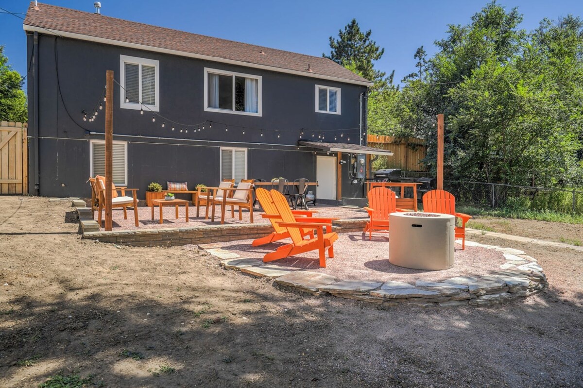 Gather around your private fire pit with vibrant orange Adirondack chairs for evening s'mores under twinkling string lights.