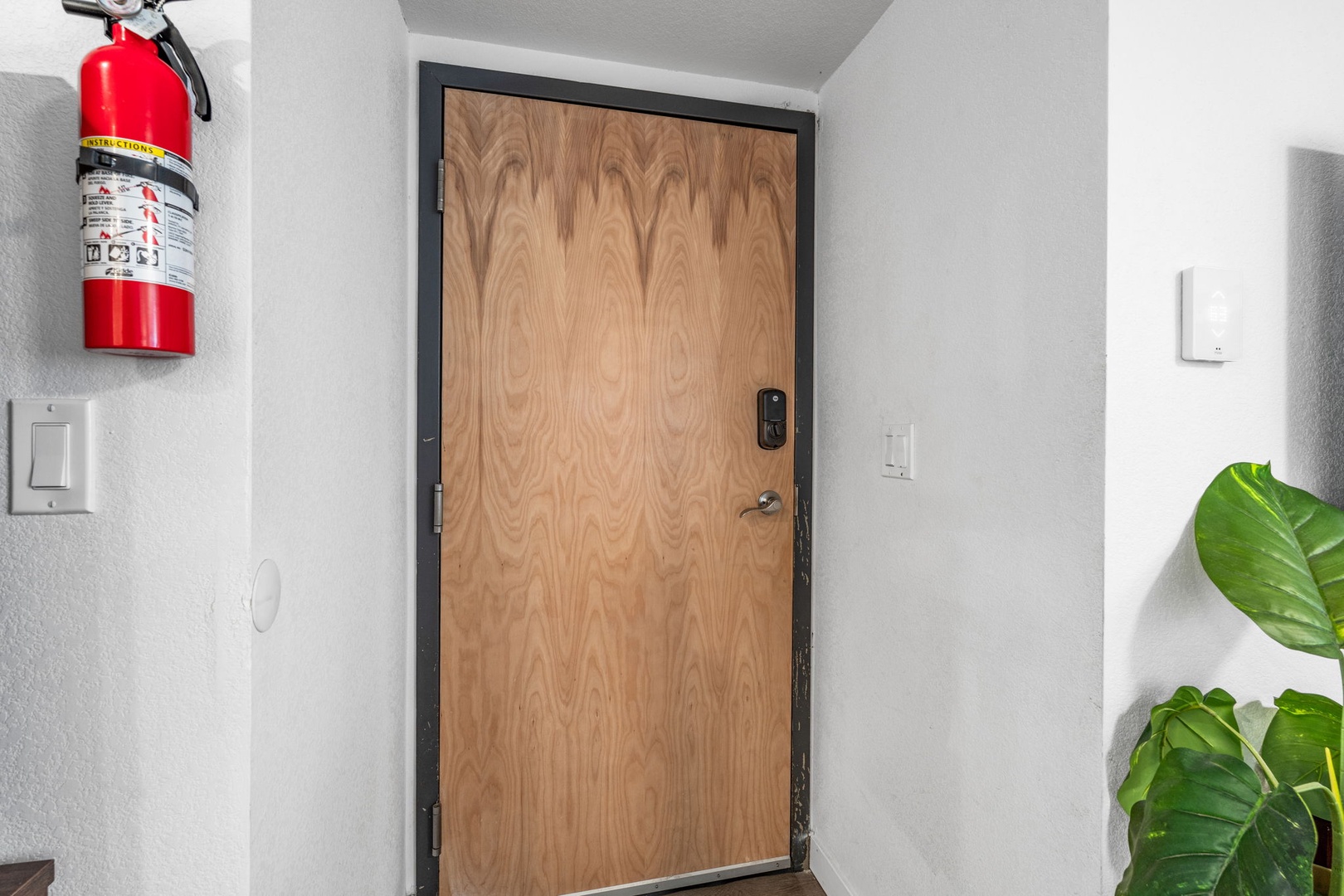 Clean hallway leading to your private entrance, complete with modern keyless entry for seamless arrivals.