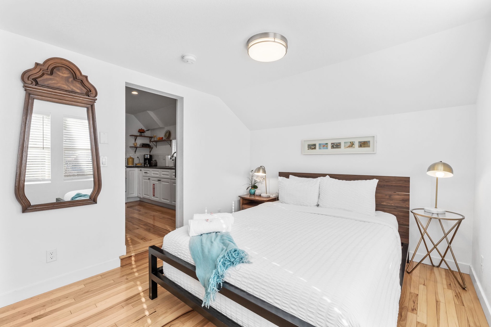 Rest peacefully in your bright bedroom with gleaming hardwood floors, crisp linens, and charming vintage touches that make this space truly special.