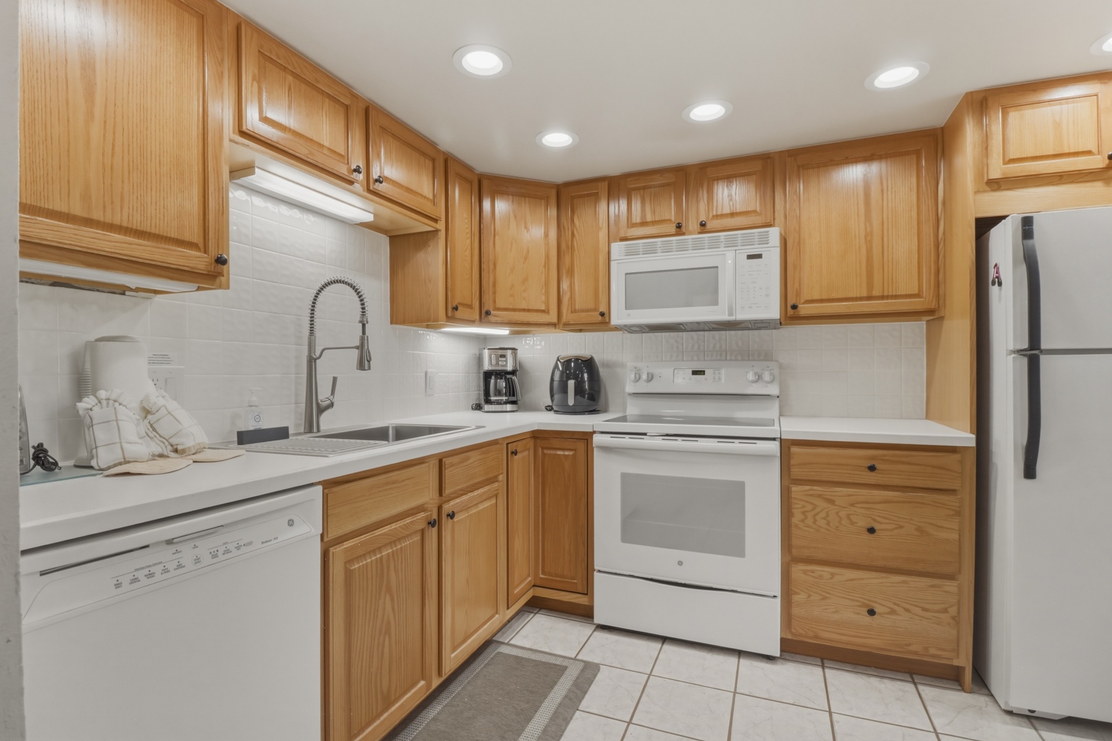 Your fully equipped kitchen awaits with warm wood cabinetry, modern appliances, and everything you need to prepare memorable meals during your stay.