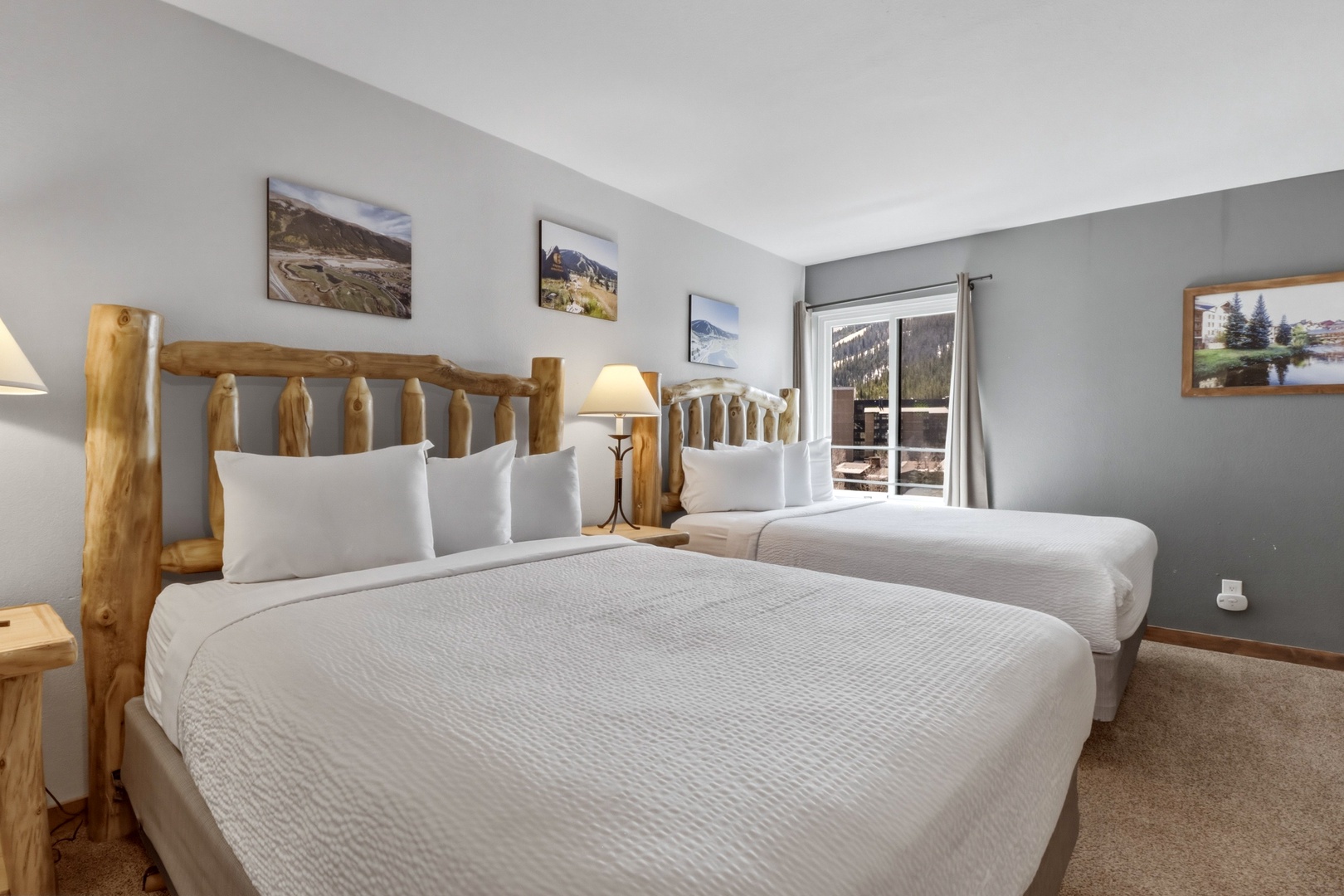 Unwind in your cozy twin room with rustic log beds, crisp linens, and mountain views from your private balcony.
