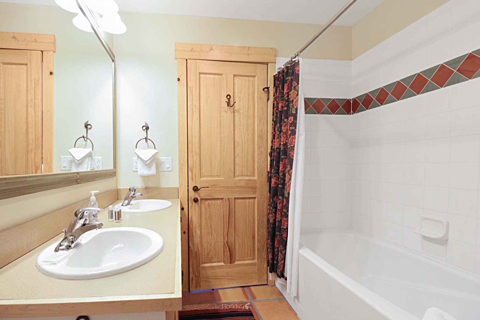Refresh in your spacious bathroom featuring dual sinks, a relaxing tub, and charming rustic touches that make your daily routine feel like a retreat.