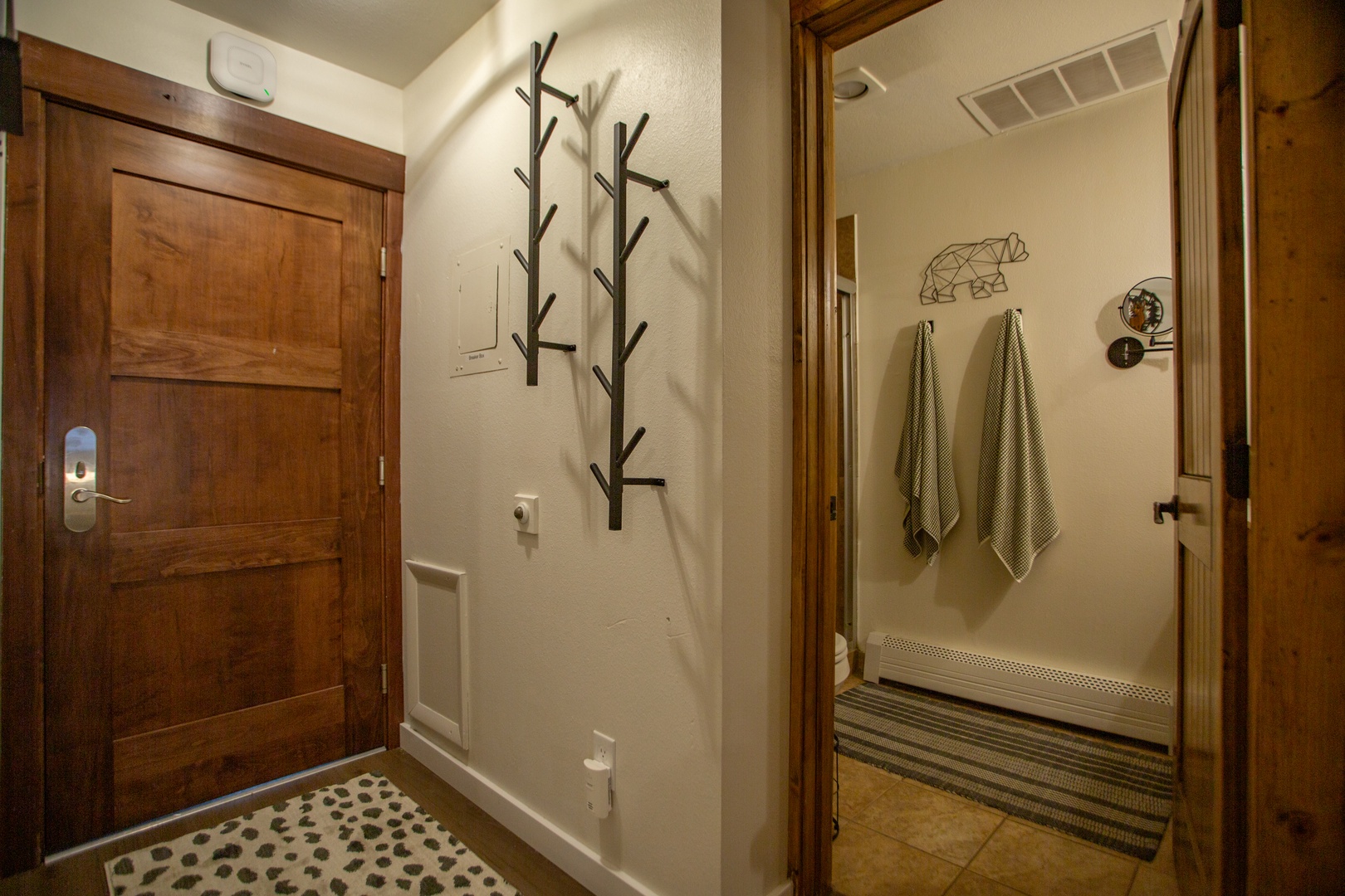 Step inside your mountain retreat where warm wood tones and thoughtful touches welcome you home. Hang your coat on the rustic branch hooks and feel the day's adventures settle as you prepare to unwind.