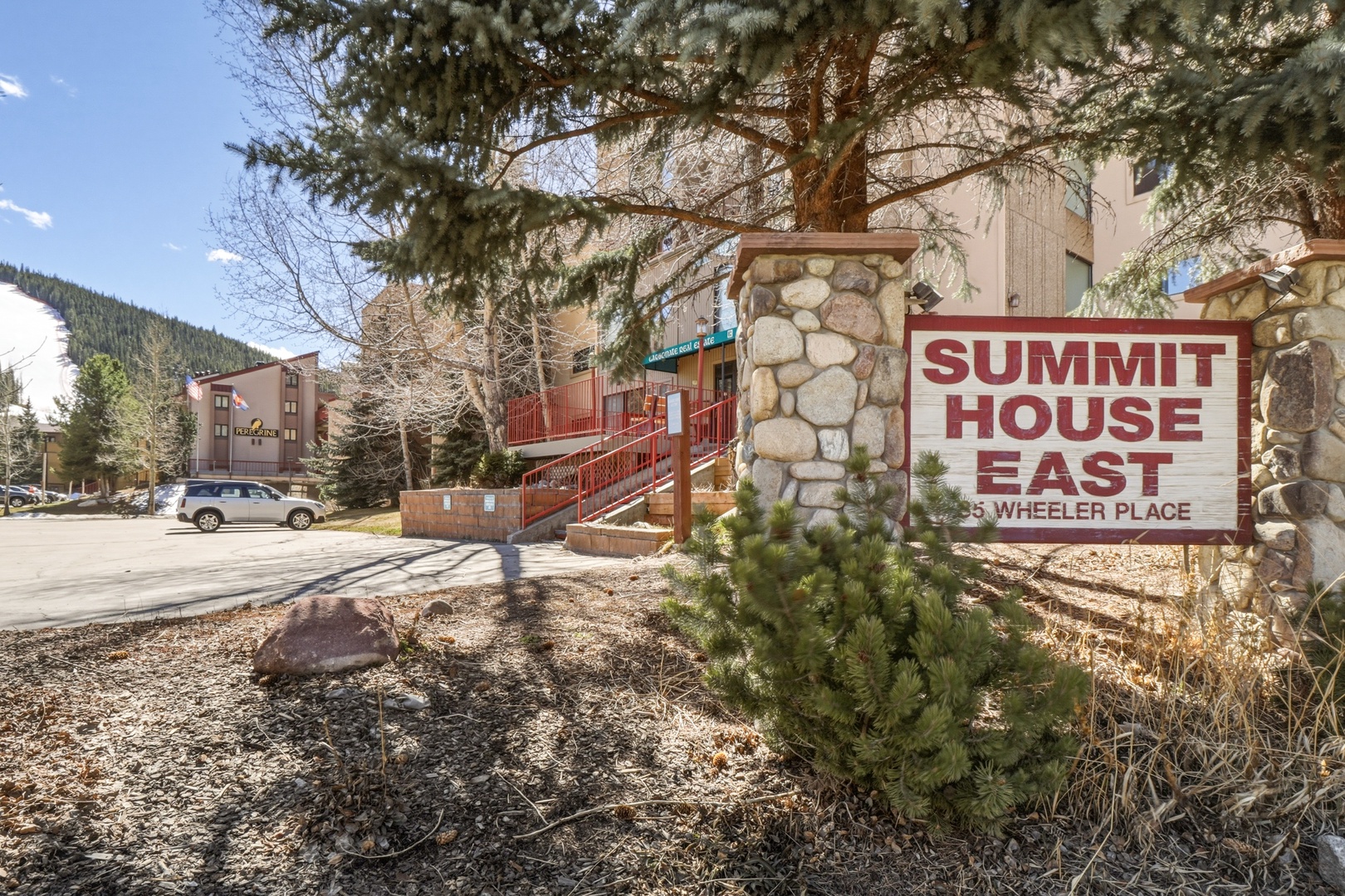Summit House East at Wheeler Place welcomes guests with mountain lodge charm and convenient parking in a scenic alpine setting.
