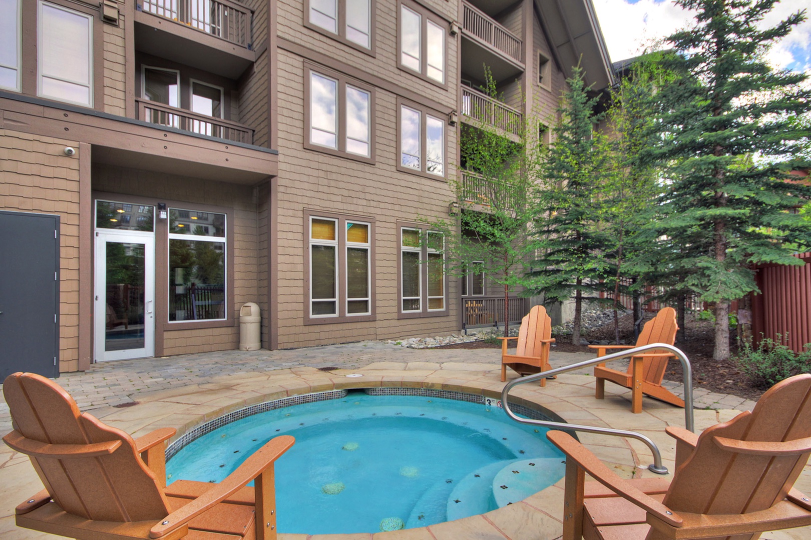 Soak your cares away in the shared hot tub, surrounded by evergreens and mountain air. Adirondack chairs invite you to linger outdoors and savor the serene alpine setting.