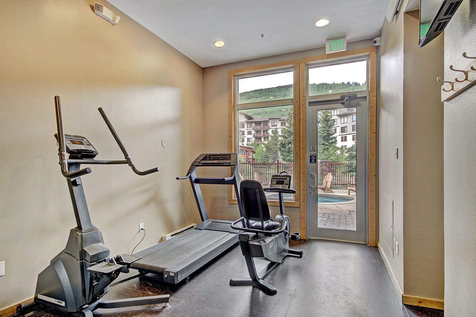 Stay active with your fitness essentials: elliptical, treadmill, and bike await your workout routine in this well-equipped space with mountain scenery just outside.