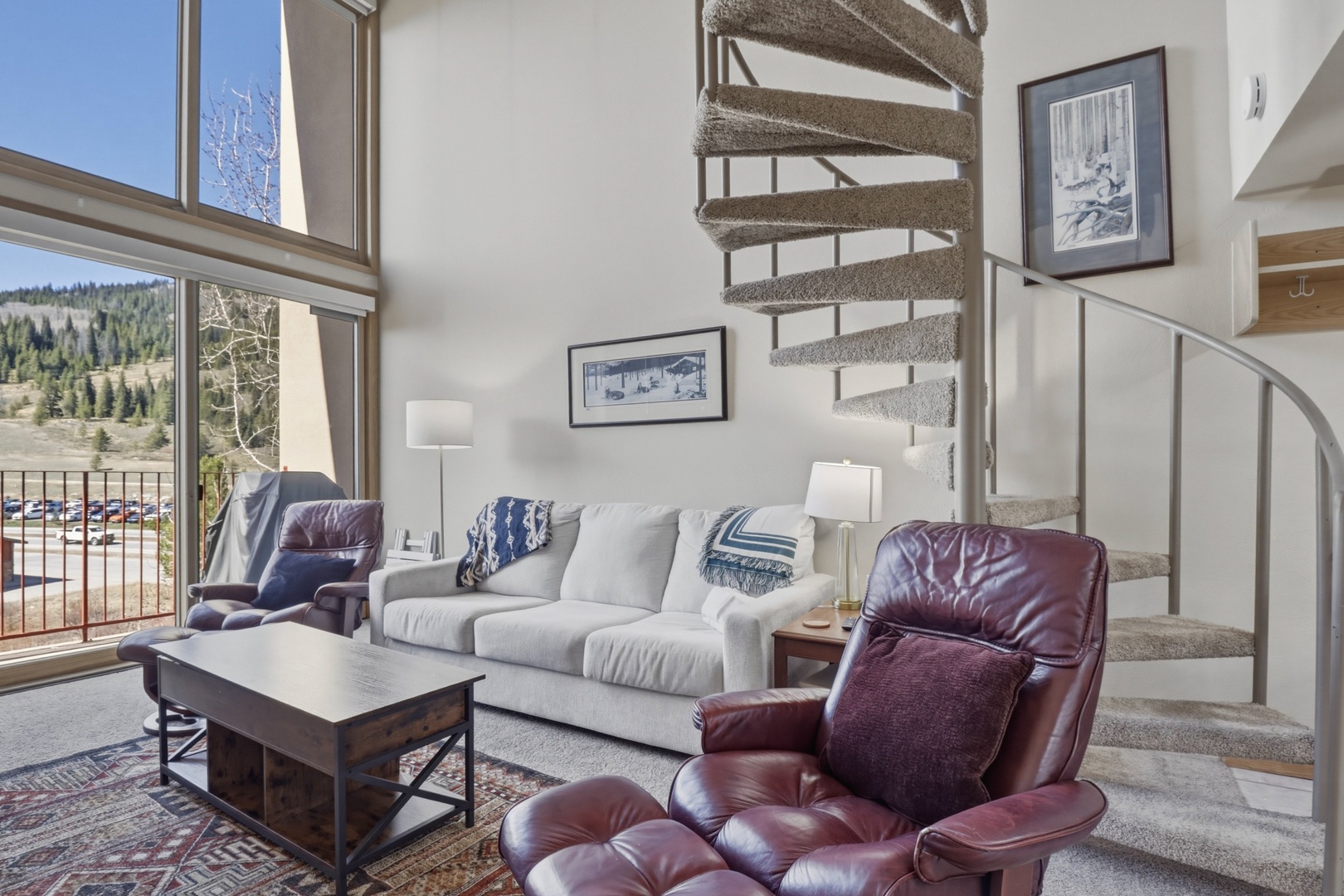 Unwind in your spacious living room where plush leather chairs and a cozy sofa create the perfect mountain retreat atmosphere.