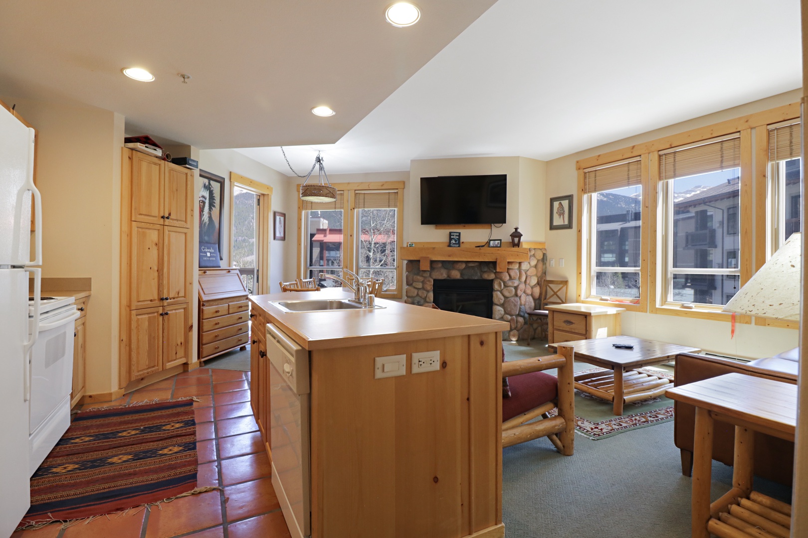 Gather around your spacious kitchen island where warm wood tones and mountain views create the perfect backdrop for memorable meals together.