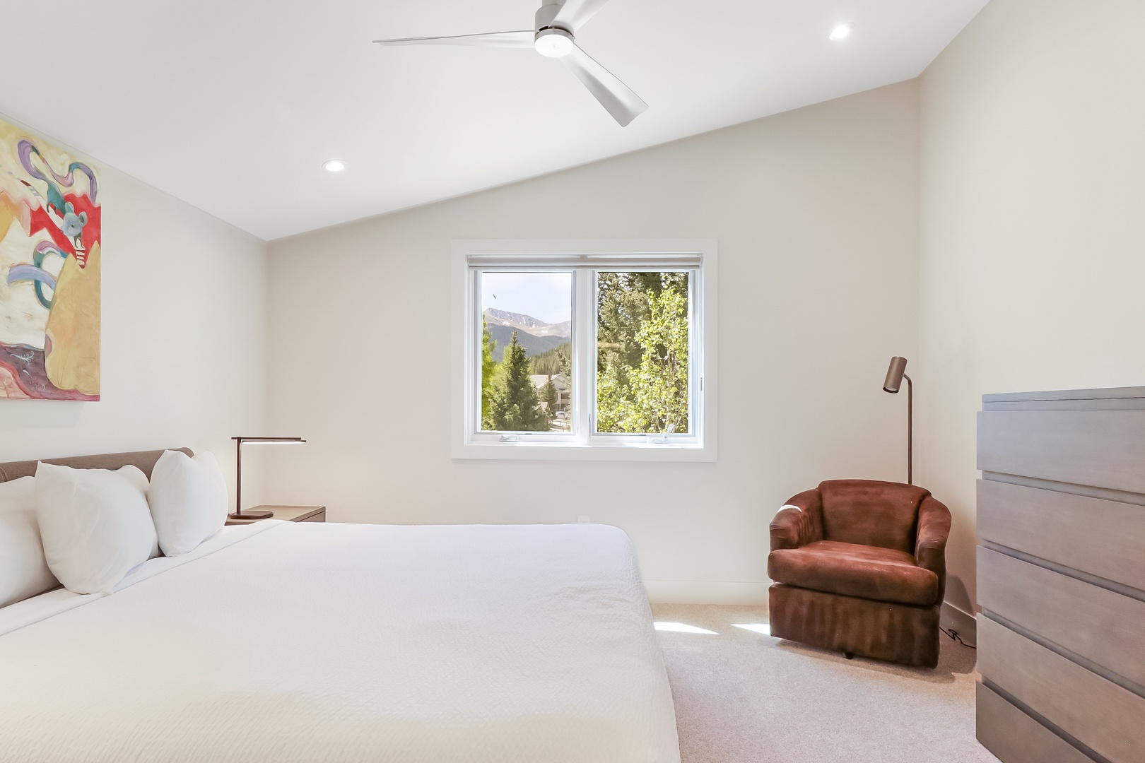 Drift off to sleep in this bright, peaceful bedroom with mountain views framing your window. Relax in the cozy leather chair or stretch out on the plush bed under the gentle ceiling fan.