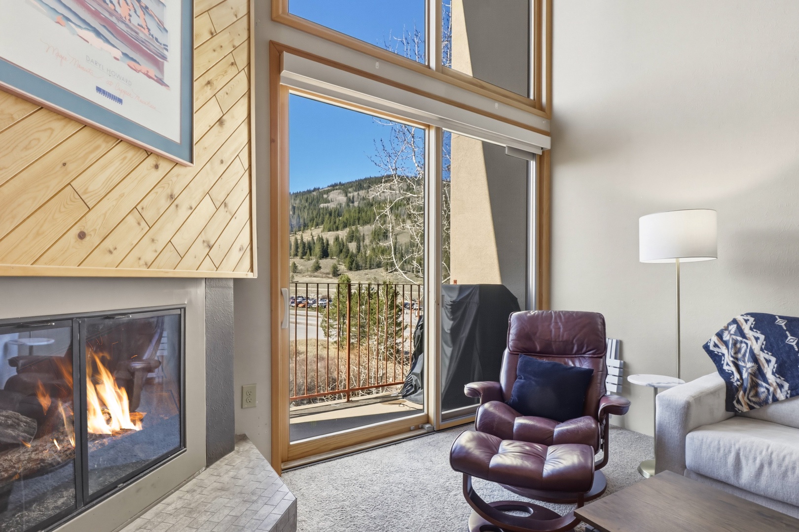 Sink into your leather chair by the crackling fireplace while gazing at stunning mountain views through floor-to-ceiling windows.
