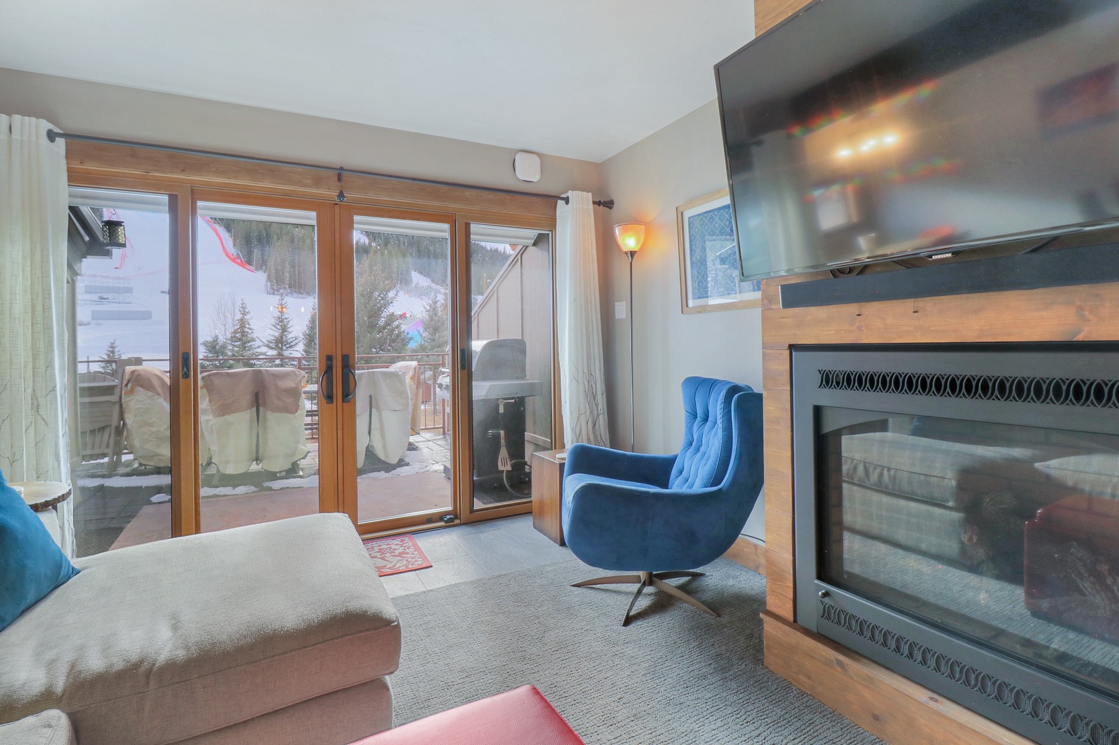 Unwind in your cozy mountain retreat where a crackling fireplace awaits and floor-to-ceiling windows frame stunning snowy vistas. Sink into plush seating and let the peaceful alpine scenery melt your stress away.