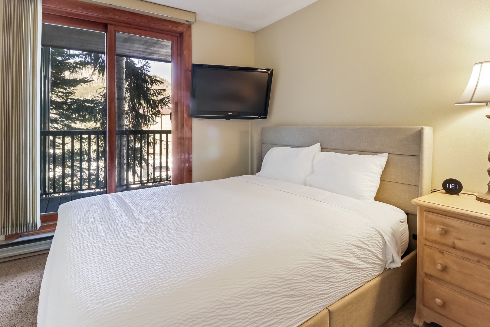 Drift into peaceful slumber in your cozy bedroom, complete with crisp linens and mountain views from your private balcony.