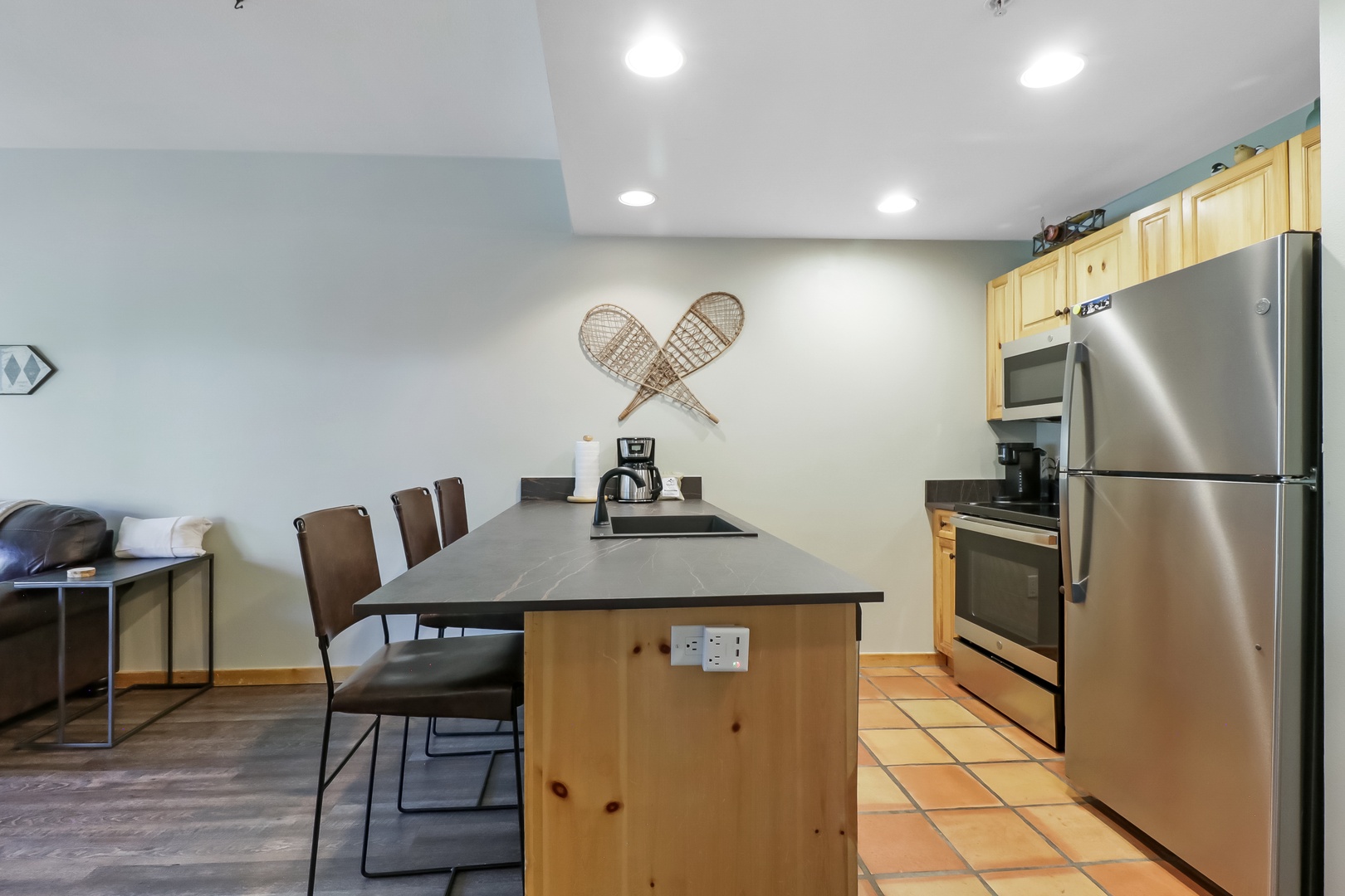 Step into your fully equipped kitchen with stainless steel appliances and a spacious island—perfect for preparing meals and gathering with friends.