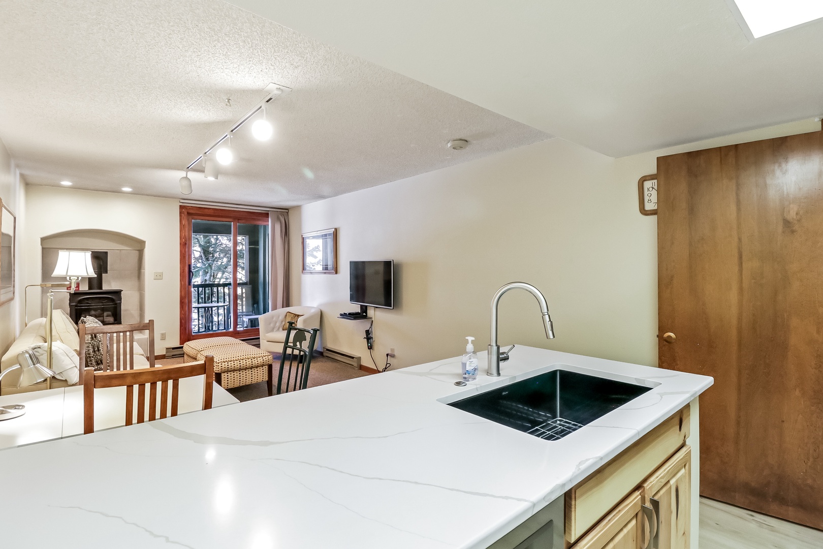 Your spacious kitchen island offers stunning quartz counters and seamless flow to the cozy living area with mountain views through the balcony doors.