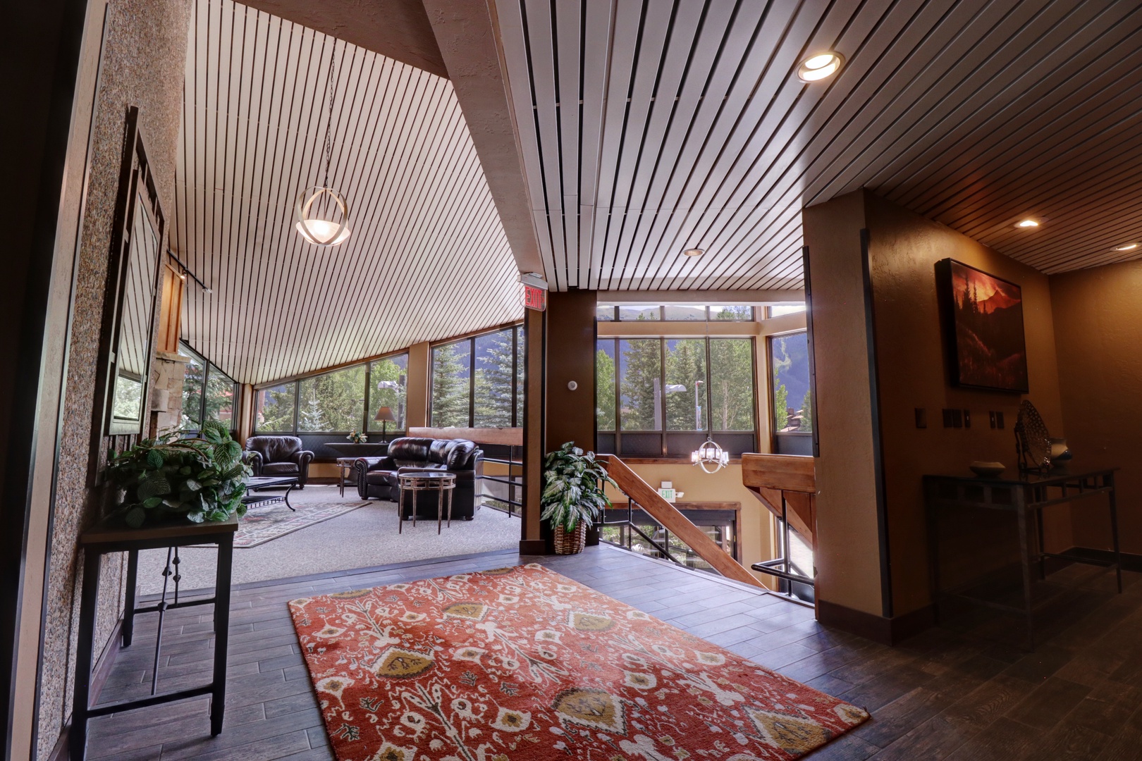 Soaring ceilings and natural light create an inviting arrival, where rich wood tones and thoughtful design set the stage for your mountain escape.