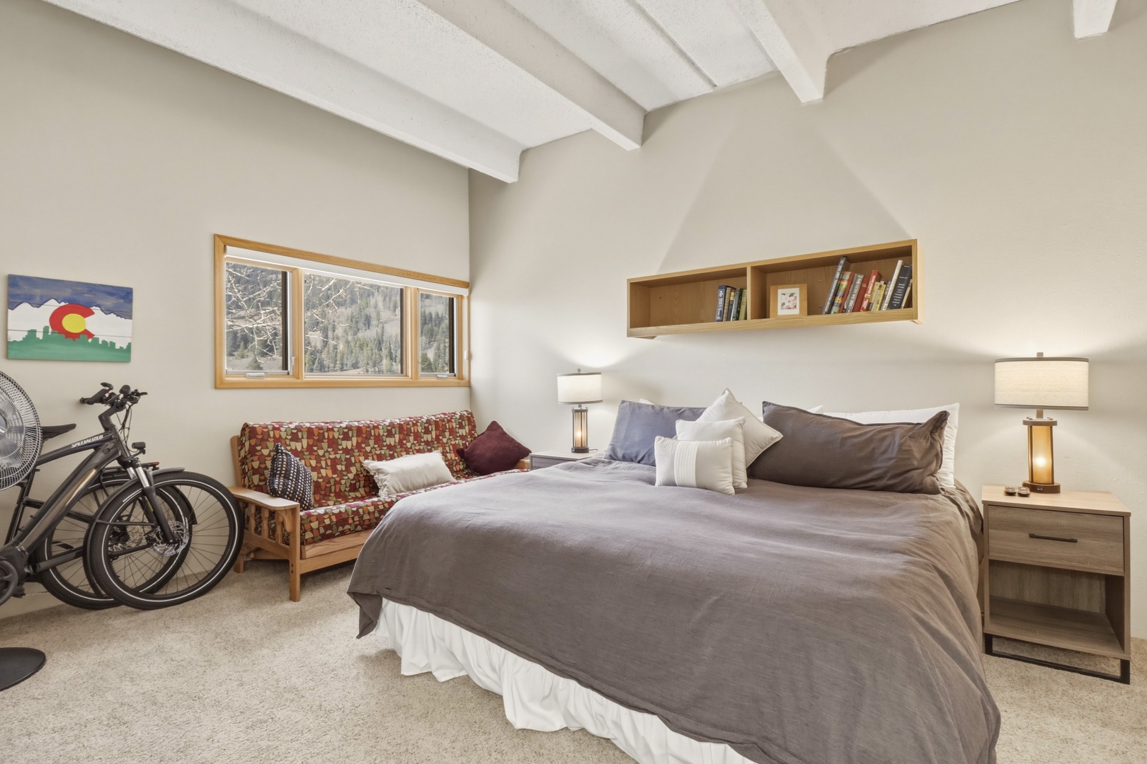 Unwind in your cozy retreat with exposed beams, mountain views, and thoughtful touches like a reading nook and bikes for exploring.