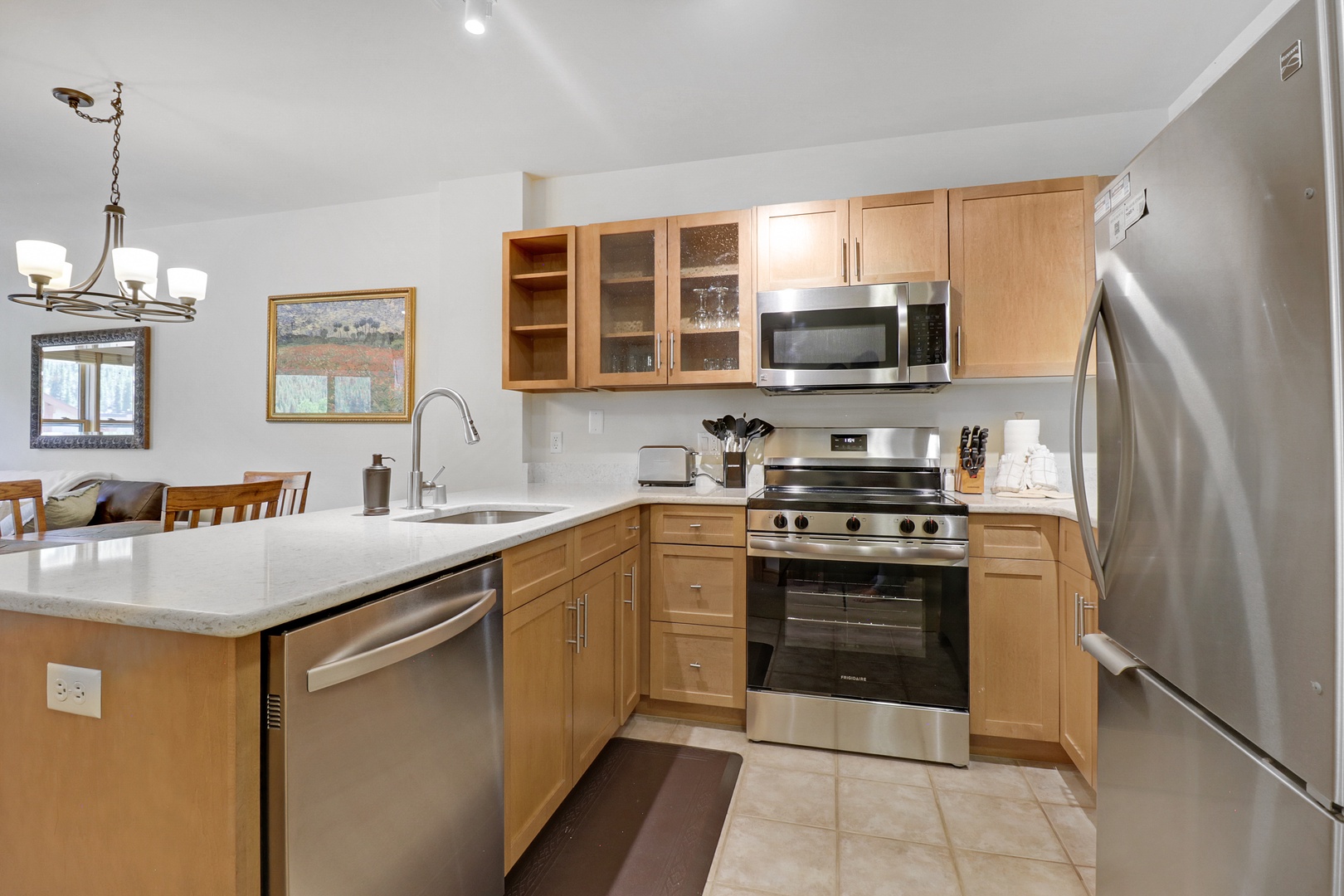 A fully equipped kitchen awaits with stainless steel appliances, ample counter space, and warm wood cabinetry perfect for preparing your favorite meals during your stay.