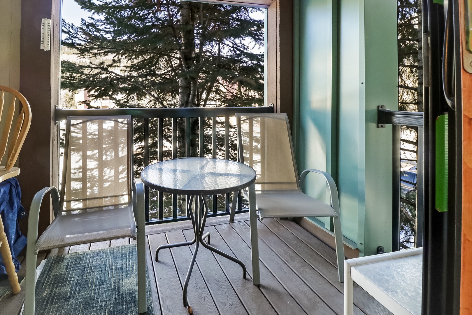 Step onto your private balcony and enjoy morning coffee surrounded by towering trees and peaceful natural views.