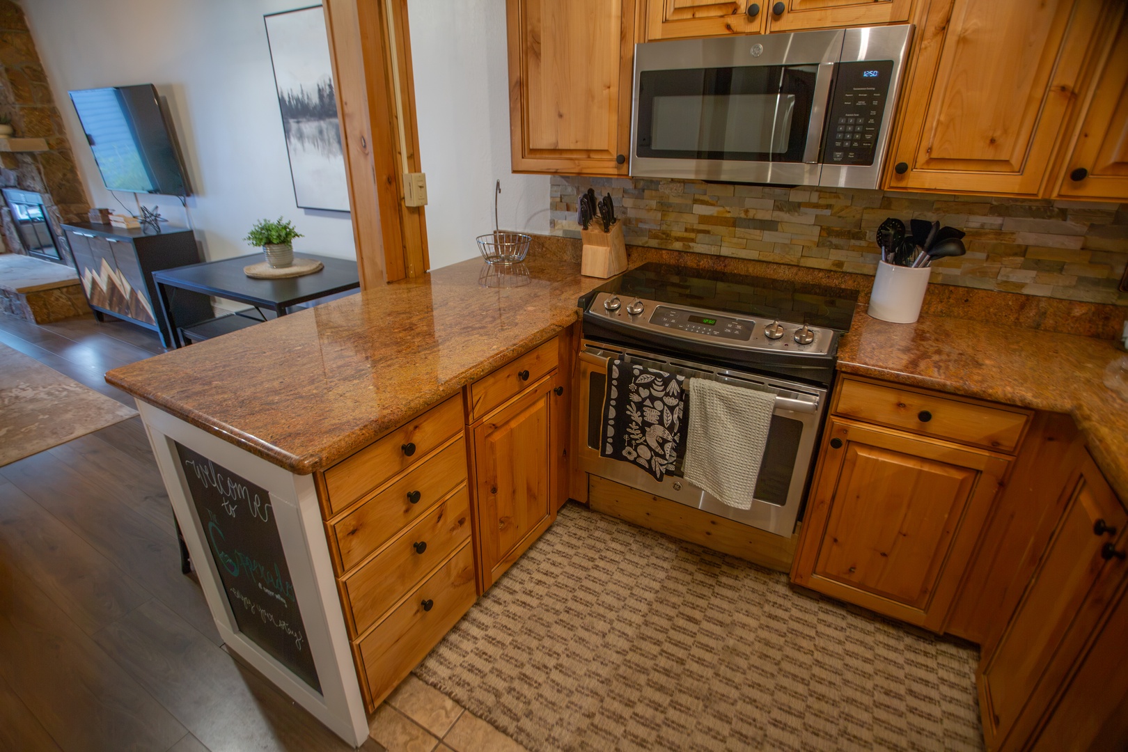 Your fully equipped kitchen features granite counters, warm wood cabinets, and stainless steel appliances ready for your home-cooked meals and morning coffee.