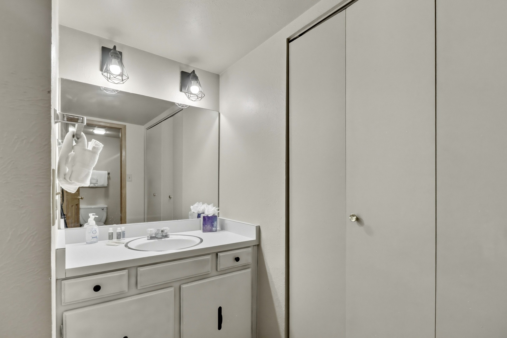 Your private bathroom features modern vanity lighting and thoughtful storage to keep your essentials organized throughout your stay.