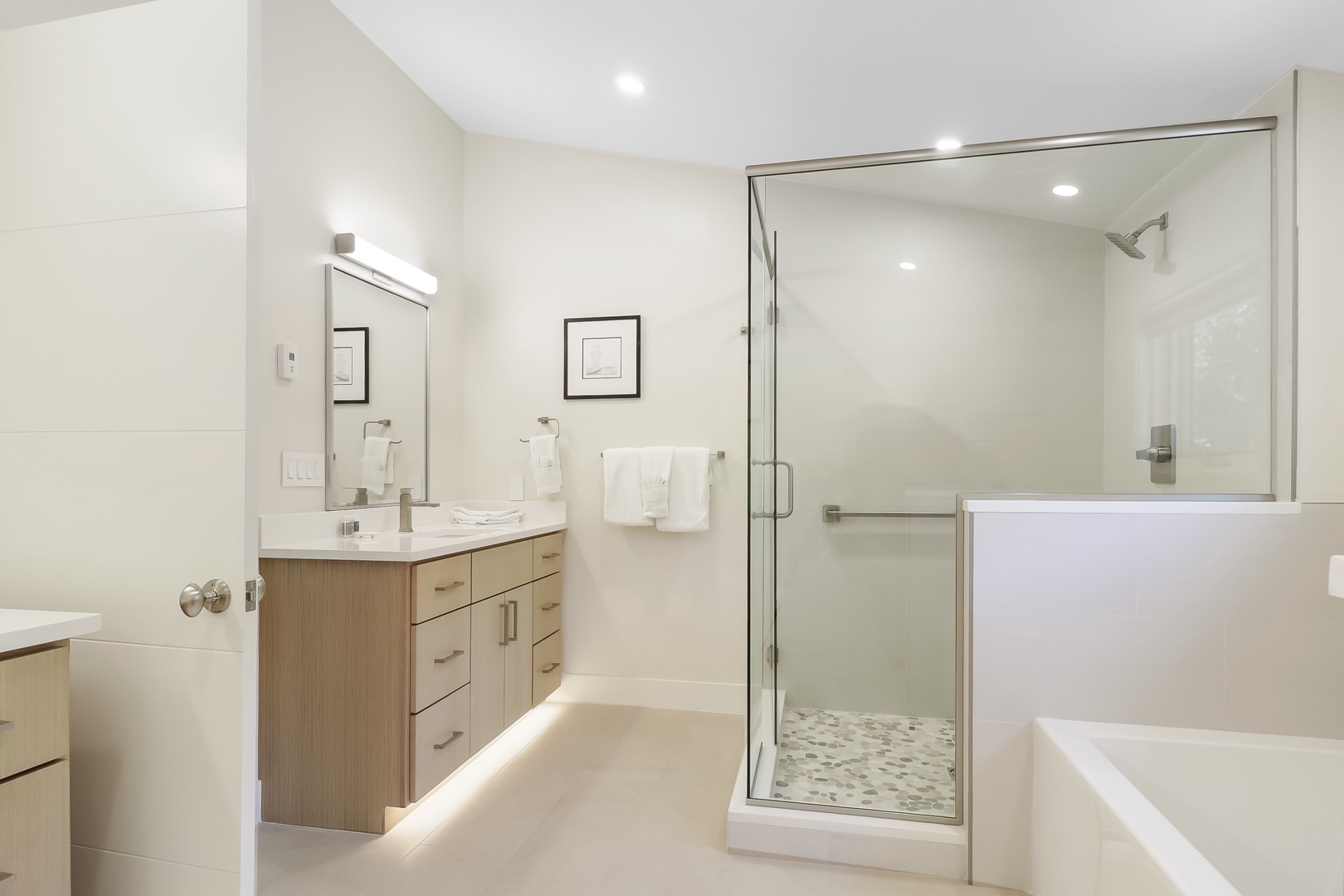 Relax in your spacious bathroom featuring a refreshing walk-in shower, soaking tub, and elegant modern finishes—designed with your comfort in mind.