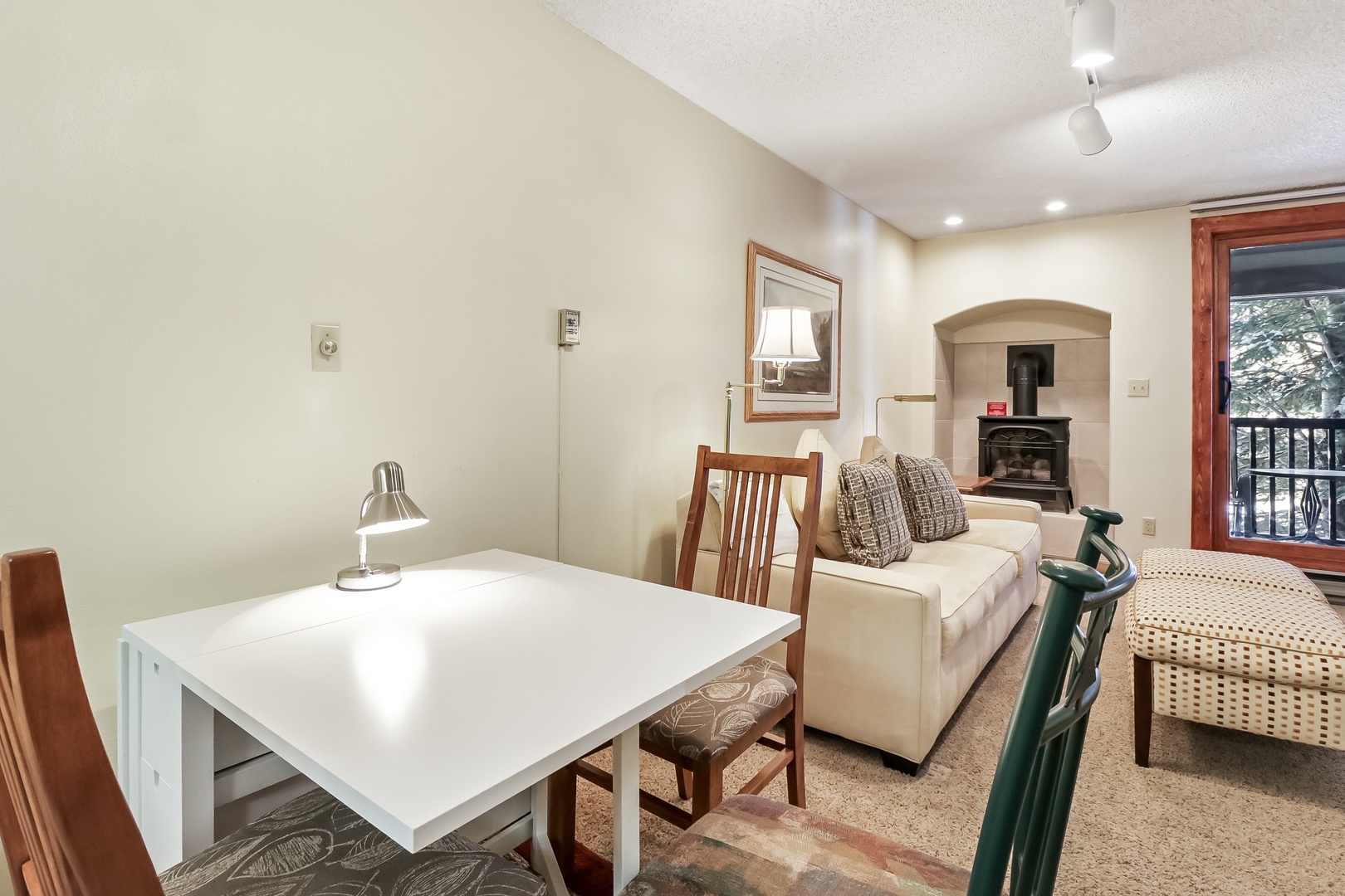 Relax in your cozy living space with a crackling fireplace, perfect dining table for meals, and comfortable seating for unwinding after adventures.