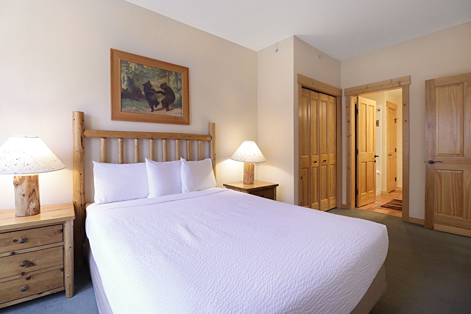 Unwind in your cozy mountain bedroom with rustic log furniture, soft white linens, and warm woodland charm.