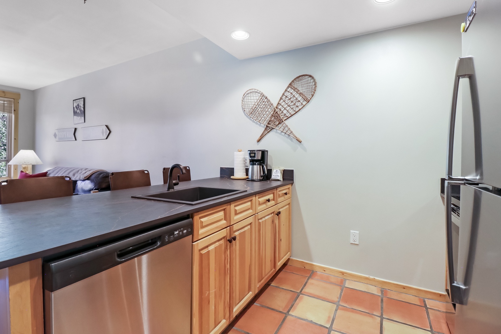 Your fully equipped kitchen features stainless appliances and warm wood cabinetry—perfect for preparing your morning coffee before hitting the slopes or enjoying family meals after a day of adventure.