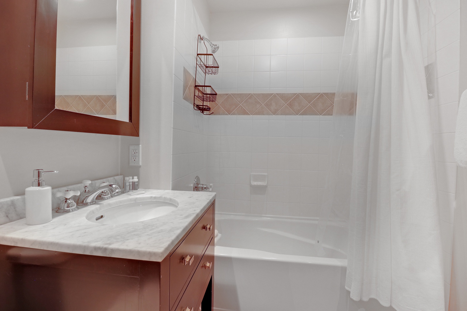 Your private bathroom features a marble vanity, soaking tub, and fresh white tile—a clean, calming space to refresh after your day's adventures.