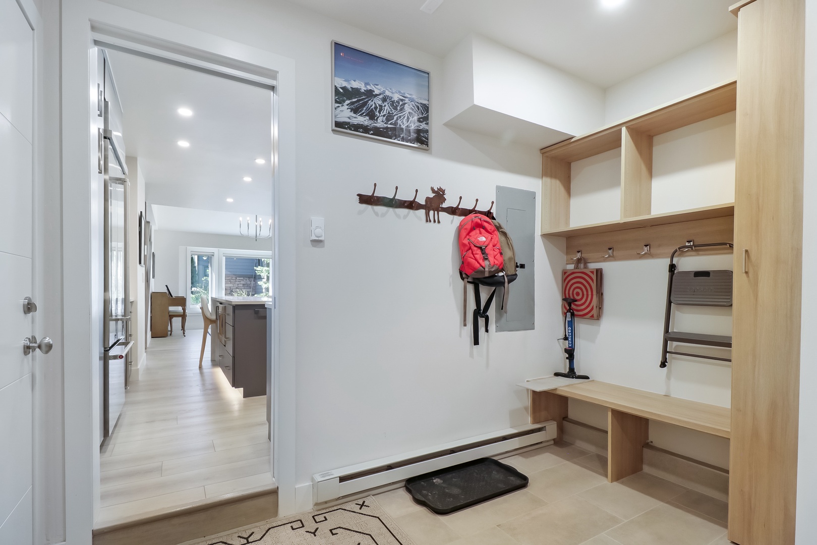 Drop your gear and step into your cozy retreat. This welcoming entry keeps outdoor essentials organized with bench storage and hooks, leading into a bright, open living area that's ready for your arrival.