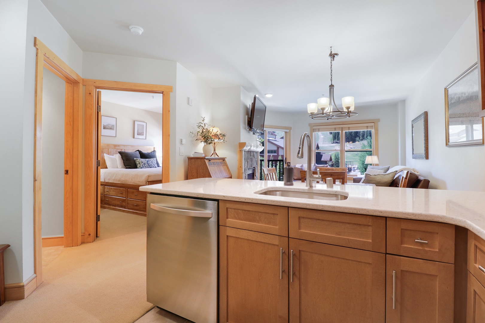 Enjoy your own chef's kitchen with stainless steel appliances, warm wood cabinetry, and an open flow into the cozy living space—ideal for gathering after a day exploring the mountains.