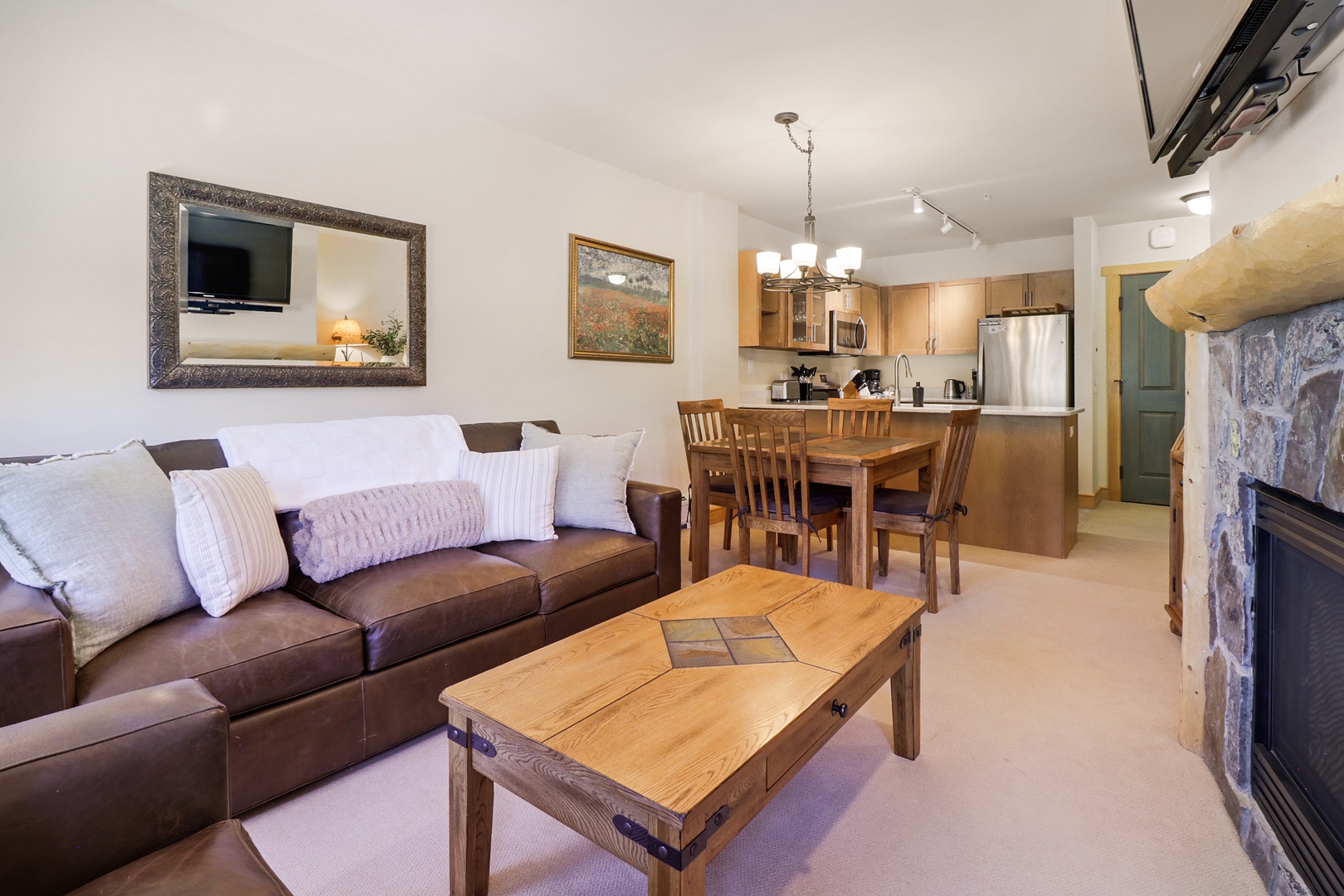 Settle into this inviting open-concept space where your living area flows seamlessly into a well-equipped kitchen. Warm wood furnishings and a cozy fireplace create the perfect retreat after a day of adventure.