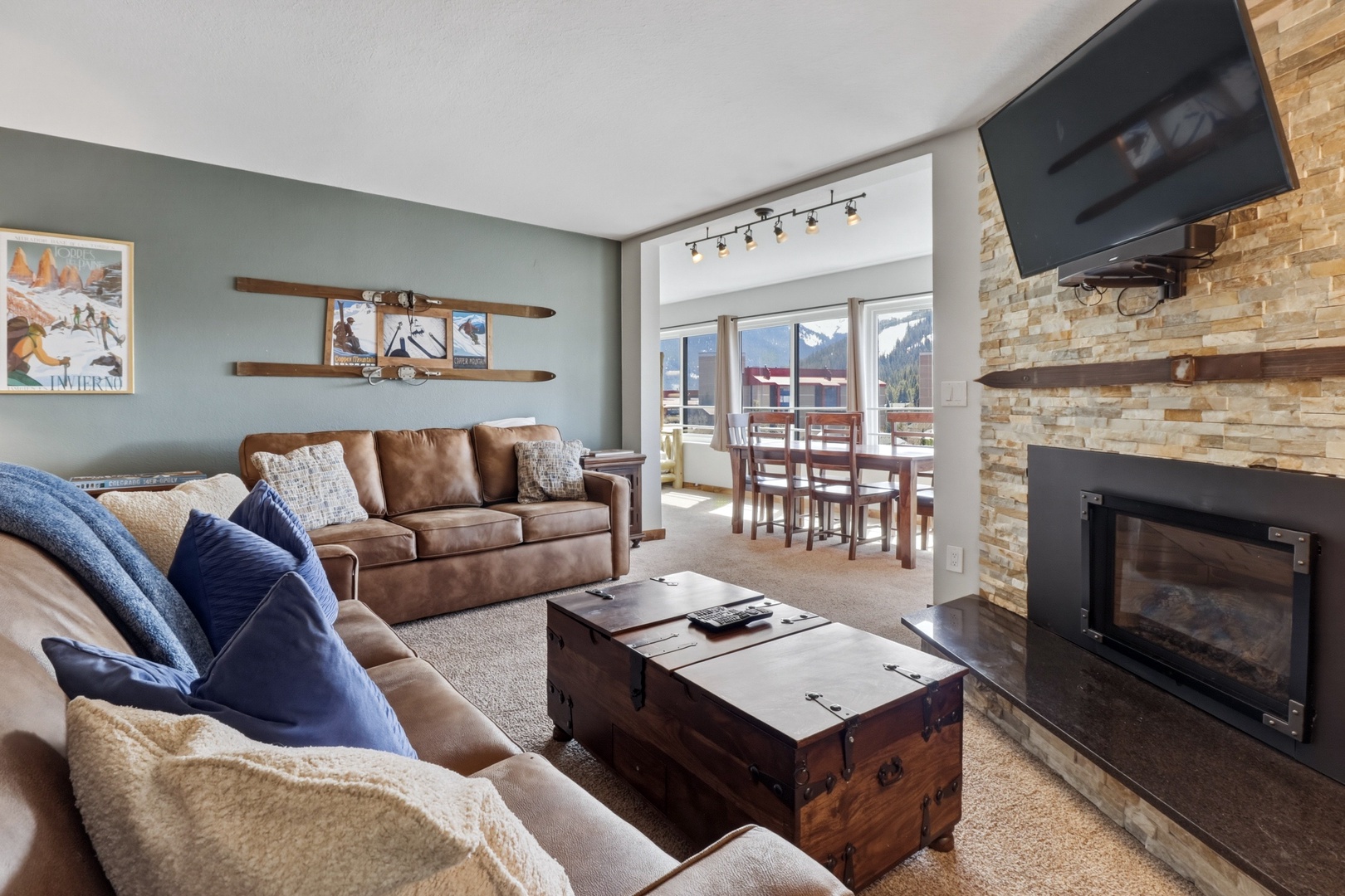 Cozy up in your mountain retreat with leather seating, crackling fireplace, and stunning ski slope views through picture windows.