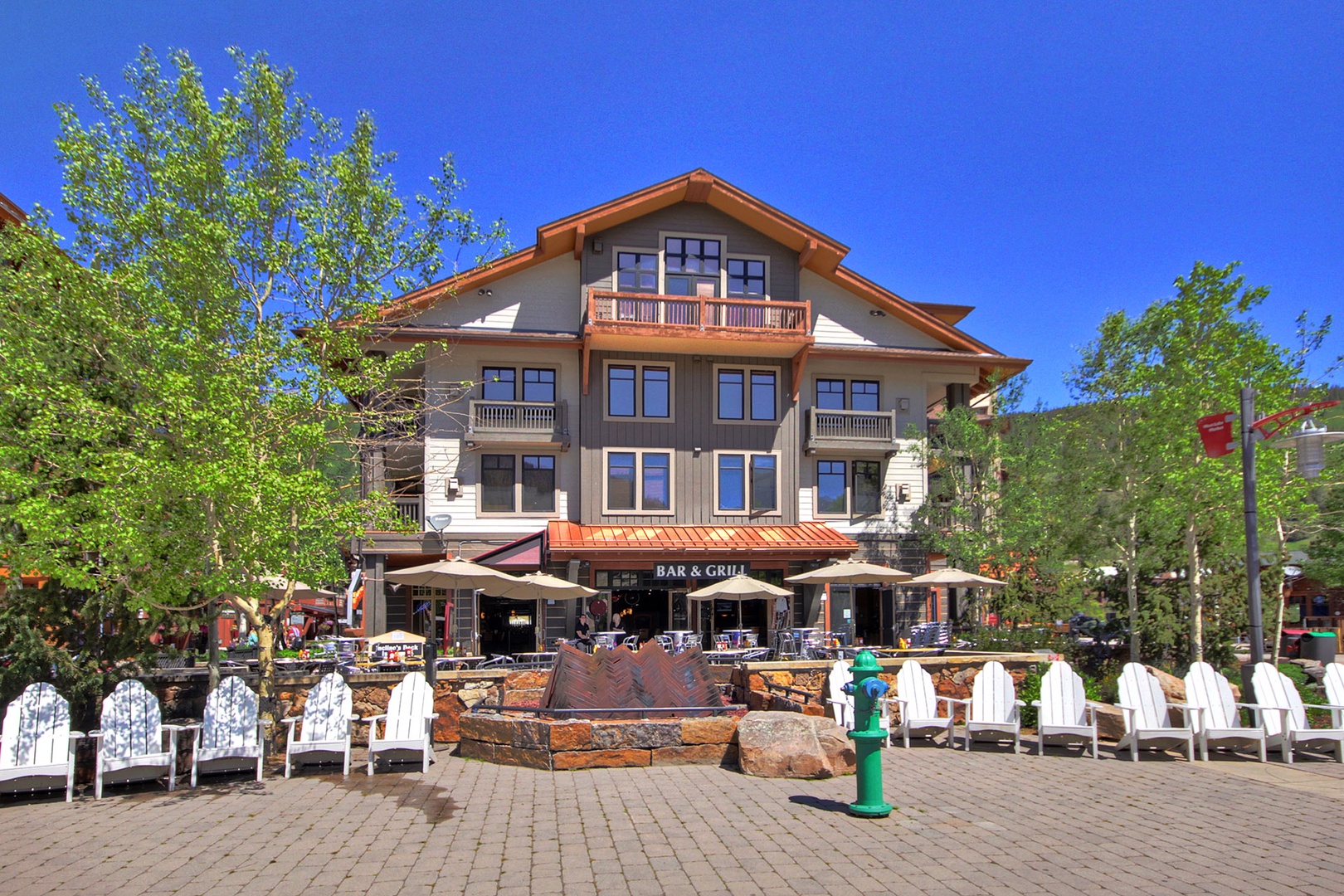 The property sits in a vibrant village setting, where mountain architecture meets alpine charm. Tree-lined streets and nearby dining create a welcoming base for your mountain getaway.