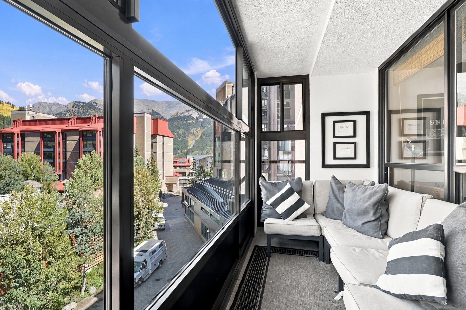 Step onto your private balcony and soak in stunning mountain views framed by floor-to-ceiling windows. Relax on plush seating as you breathe in fresh alpine air and watch the town below come to life.