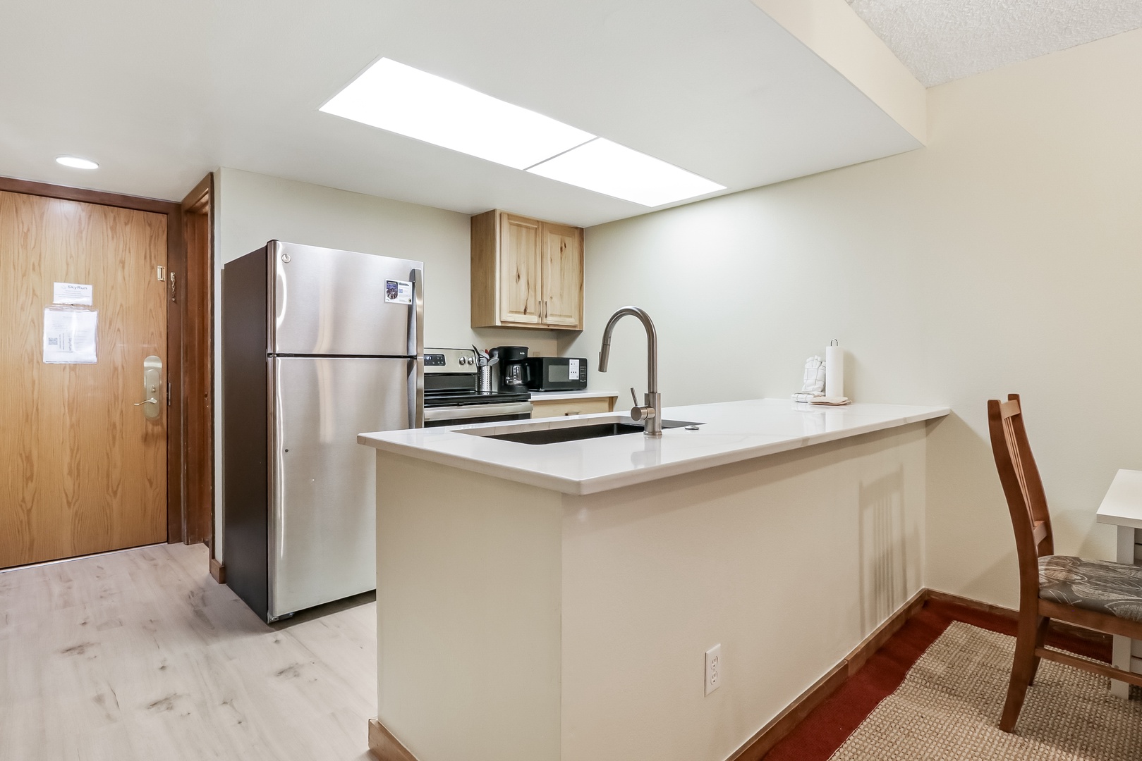 Your bright, modern kitchen features sleek appliances and a spacious island perfect for morning coffee or preparing meals during your stay.