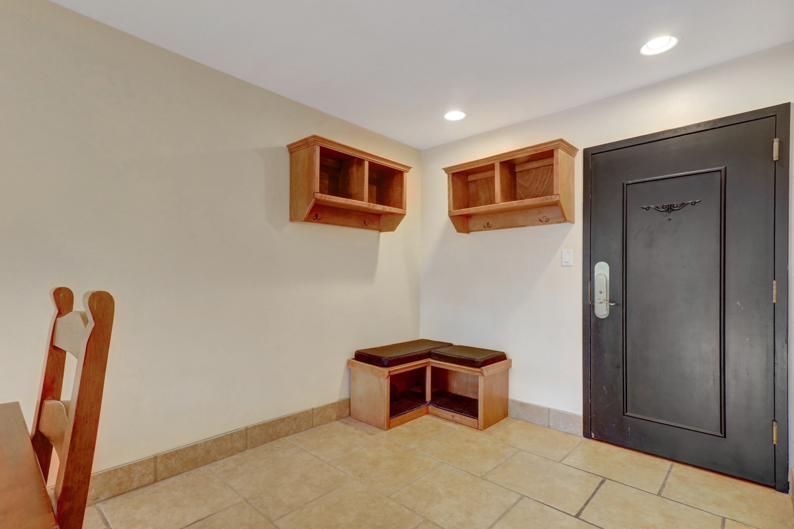 Practical entryway featuring built-in cubbies and a cushioned bench, perfect for organizing gear and getting ready for a day on the slopes.