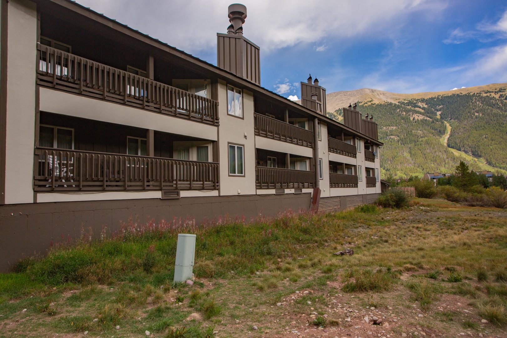 Mountain vacation property featuring multiple balconies and surrounded by natural alpine landscape and scenic views.