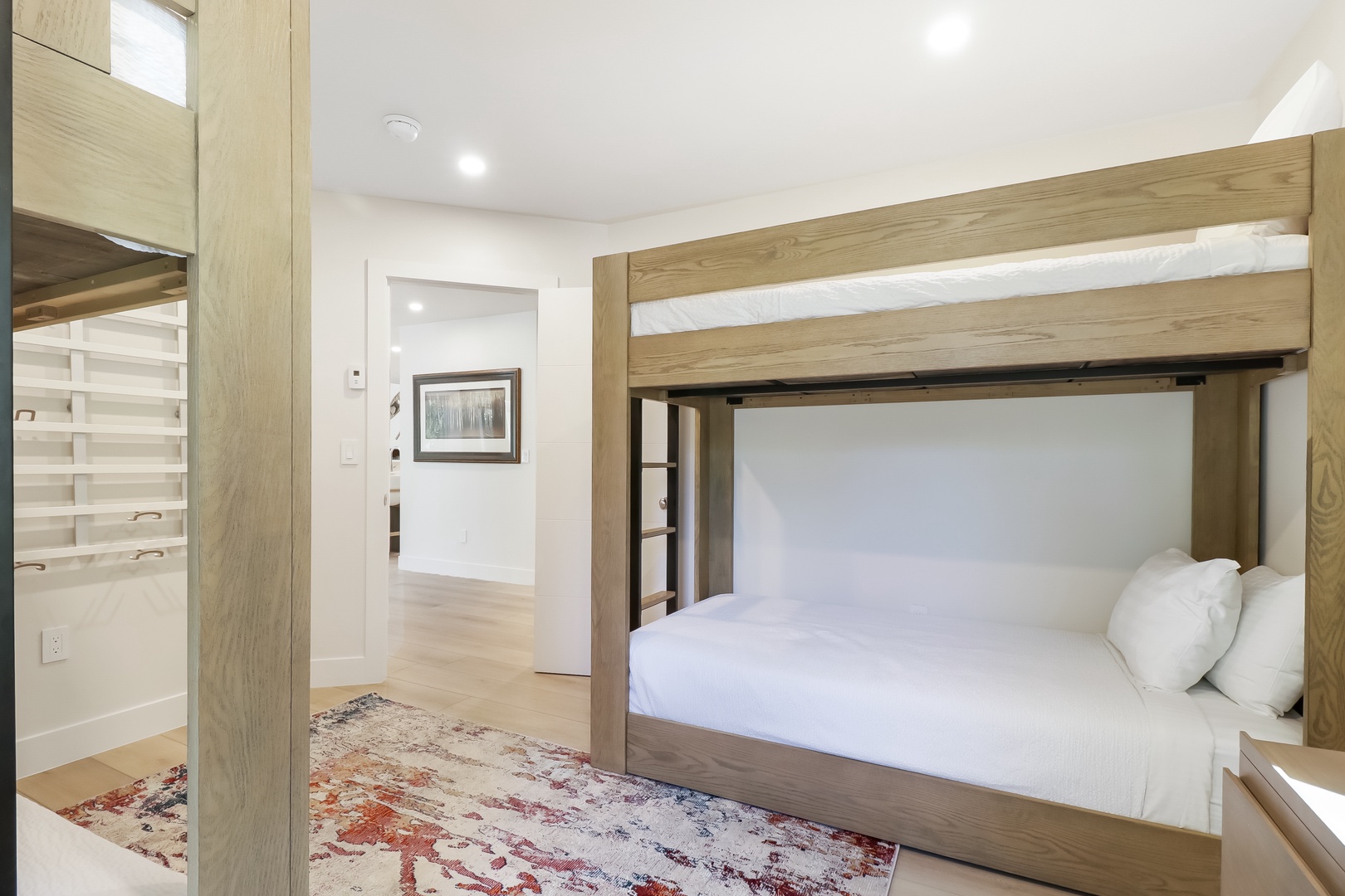 Your spacious room features a stylish bunk bed with crisp linens and a cozy rug underfoot—perfect for families or groups looking to relax together.