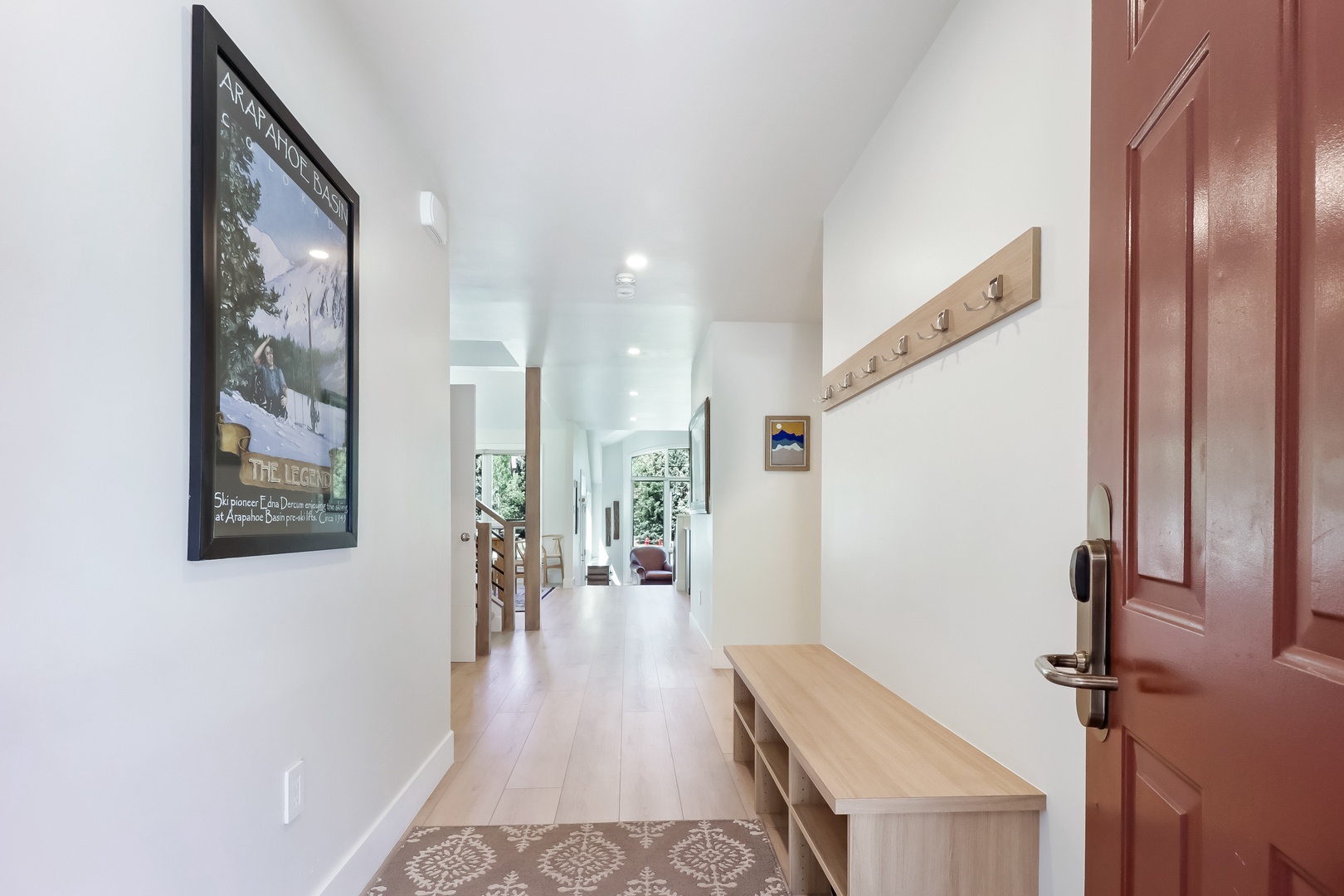 Step into a bright, welcoming entryway with soaring ceilings and natural light that draws you toward inviting living spaces beyond.