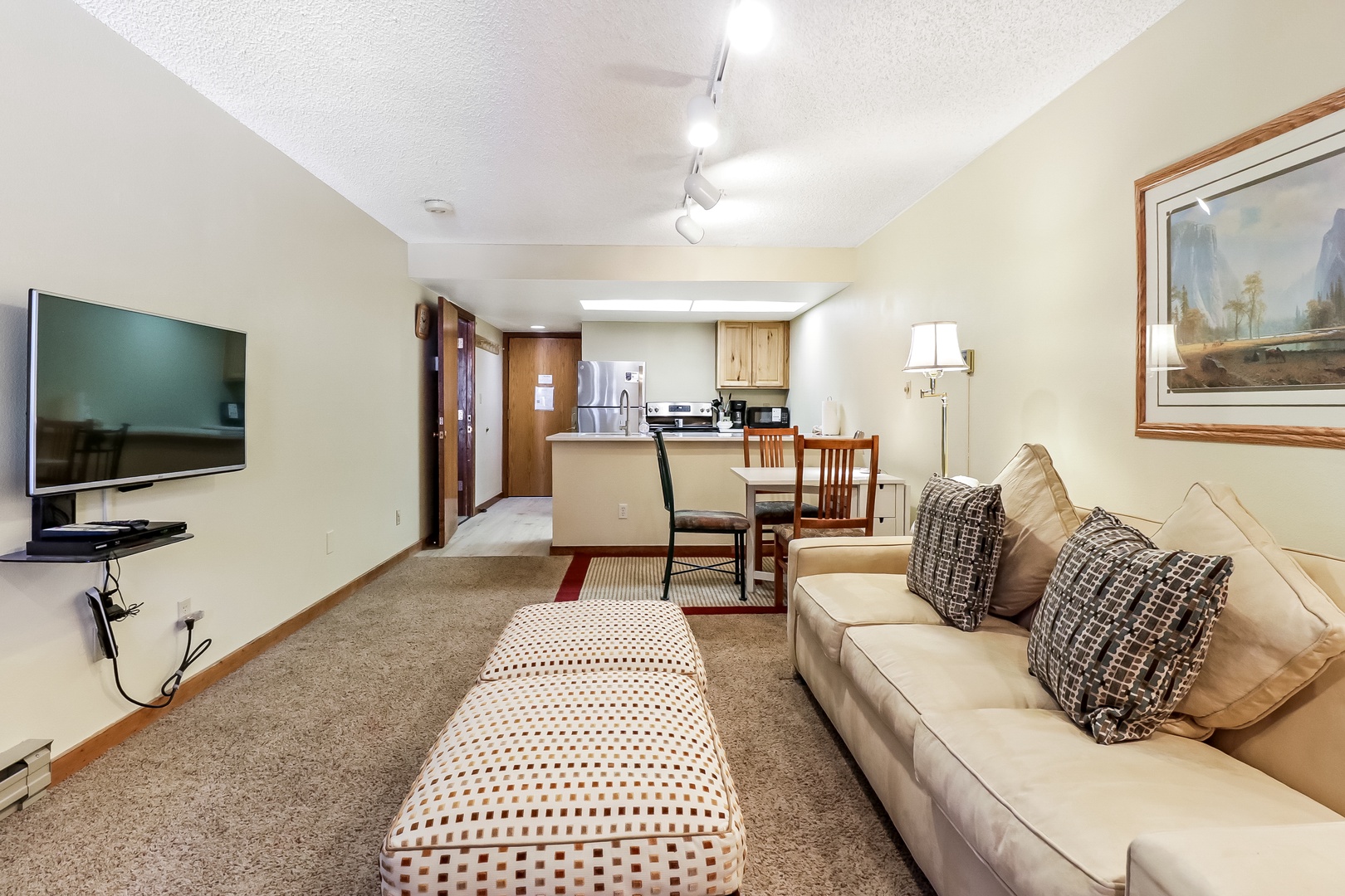 Your spacious suite combines comfort and convenience with a plush sofa, full kitchen, and dining area for memorable stays.