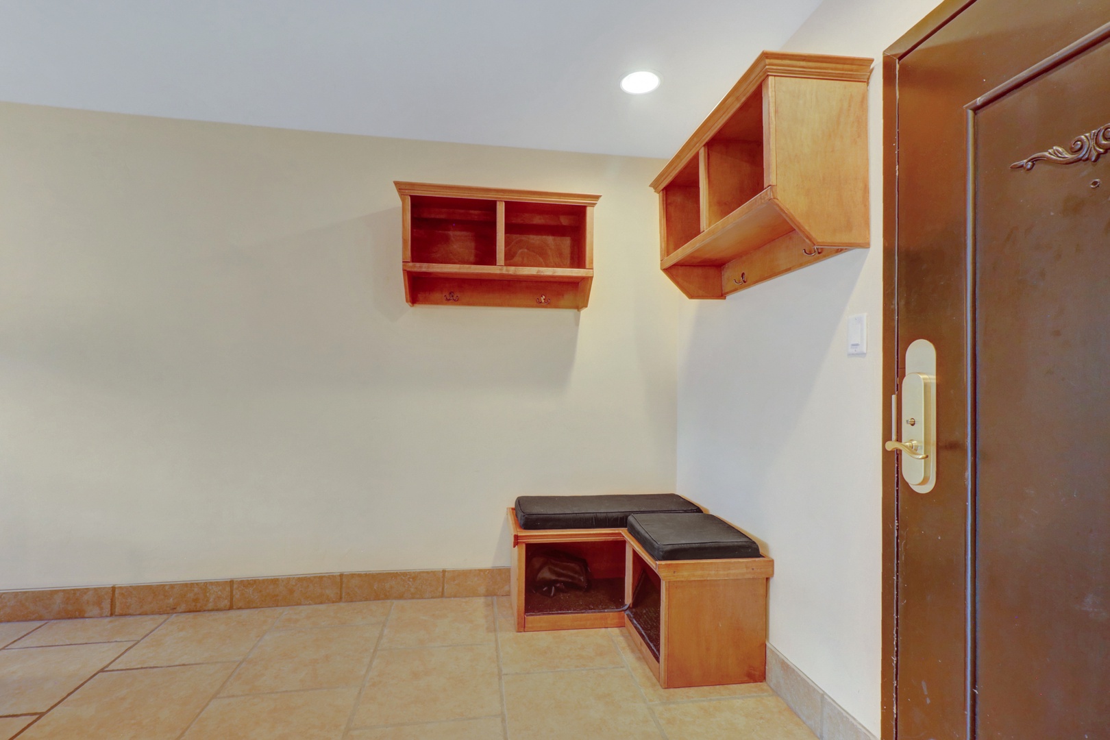 Practical entryway featuring built-in cubbies and a cushioned bench, perfect for organizing gear and getting ready for a day on the slopes.