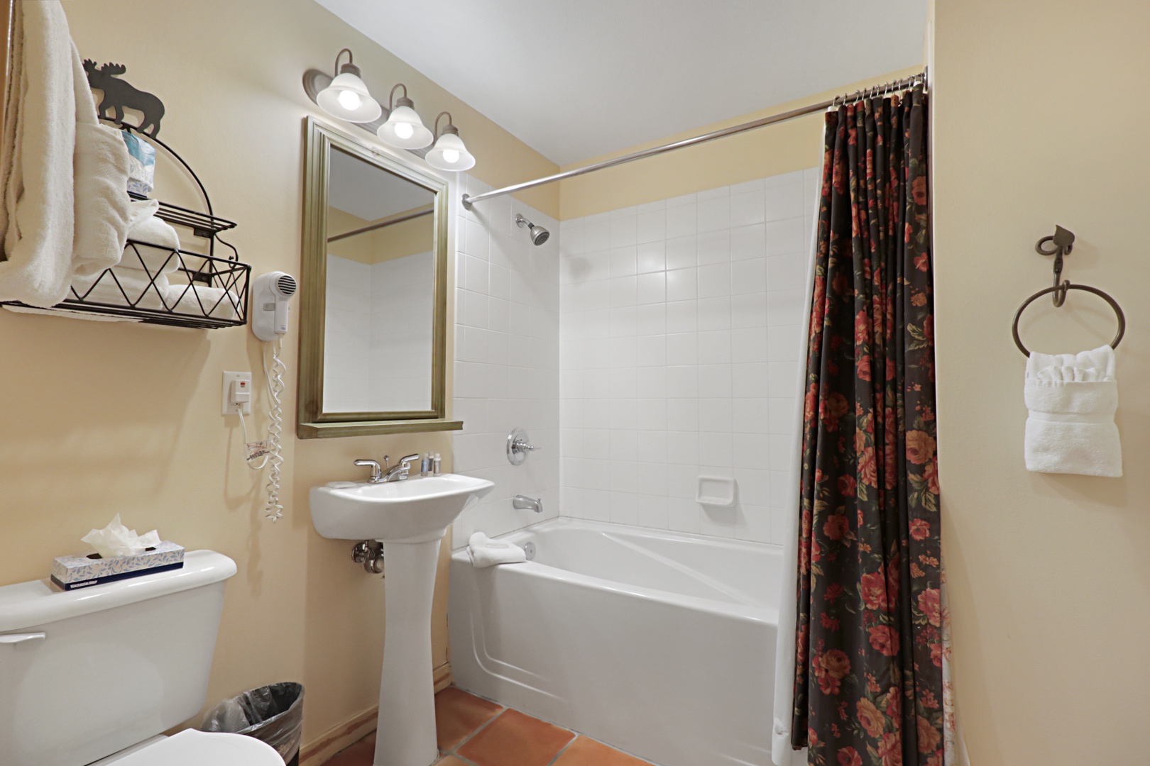 Unwind in your private bathroom featuring a relaxing tub-shower combo, fresh towels, and thoughtful amenities for your comfort.